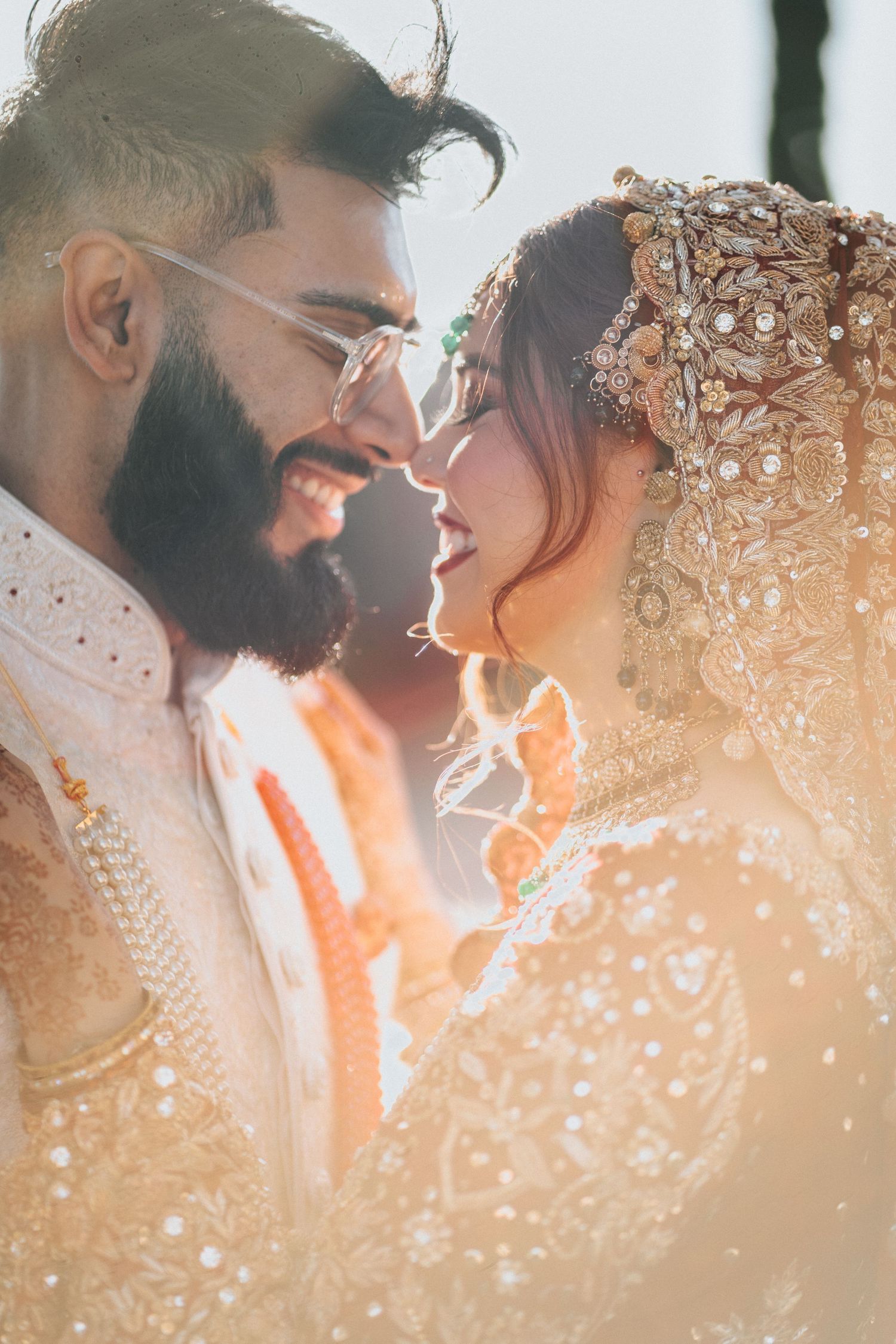 Romantic couple in formal attire with sparkly bokeh lighting effects.