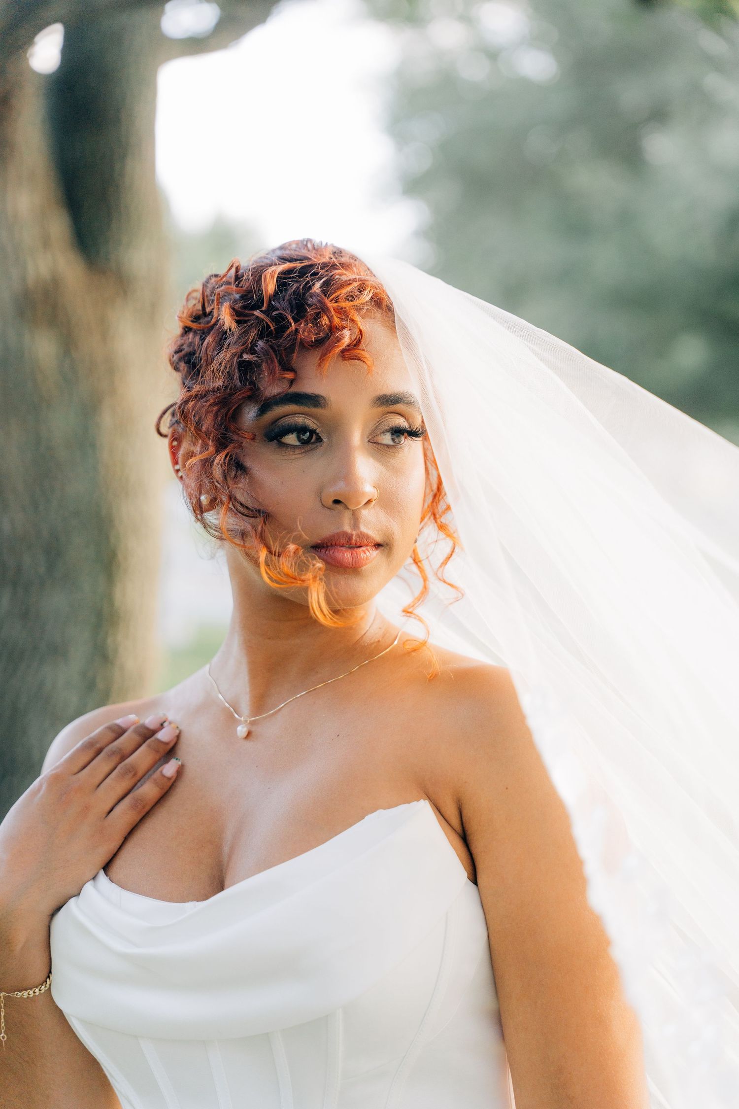 Artistic bridal portraits featuring a woman in white with vibrant curly orange hair.