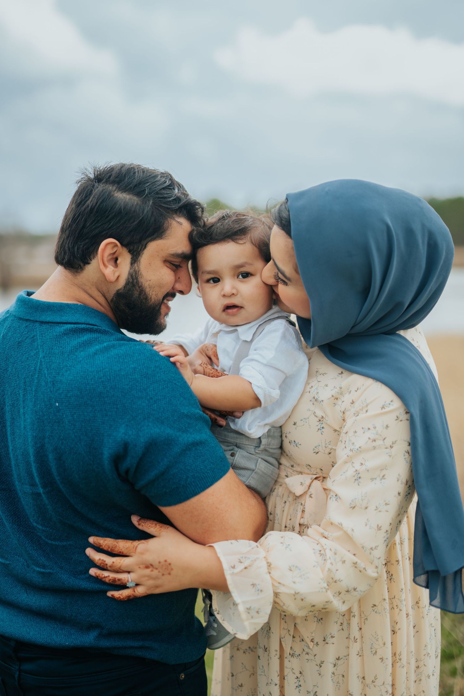 Intimate family moments captured outdoors showing tender interactions and embraces.