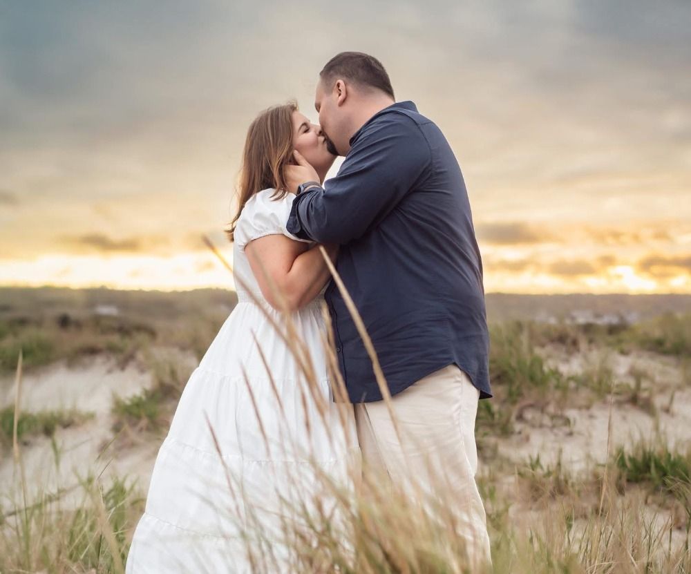 Intimate couple portrait session in coastal dunes during sunset.