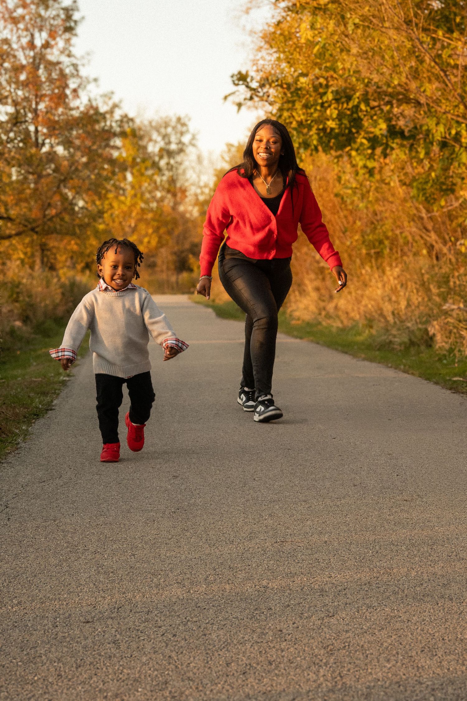 Action sequence of people running and jumping on path during golden hour sunset.