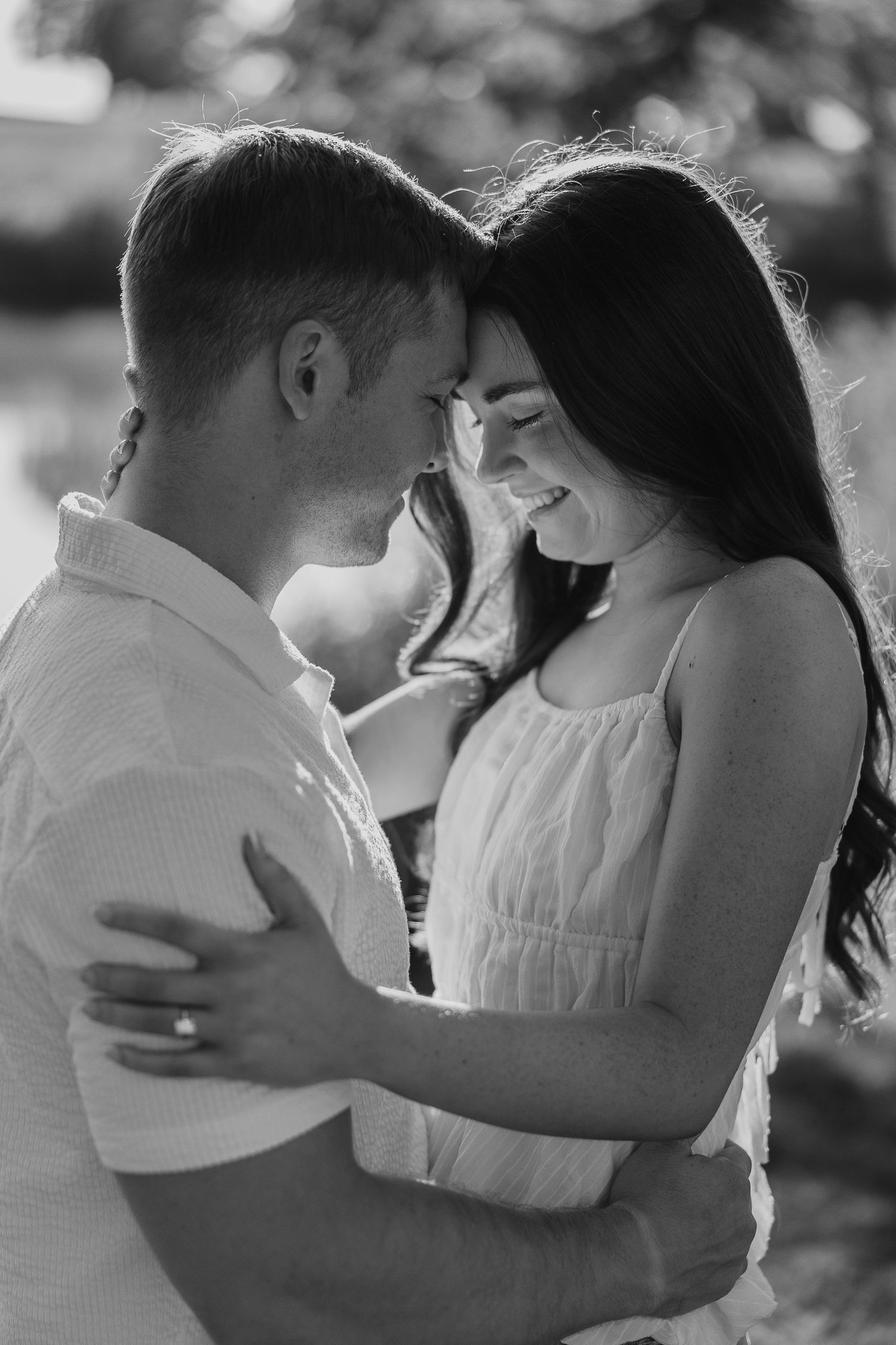 Black and white series captures intimate moments between couple outdoors.