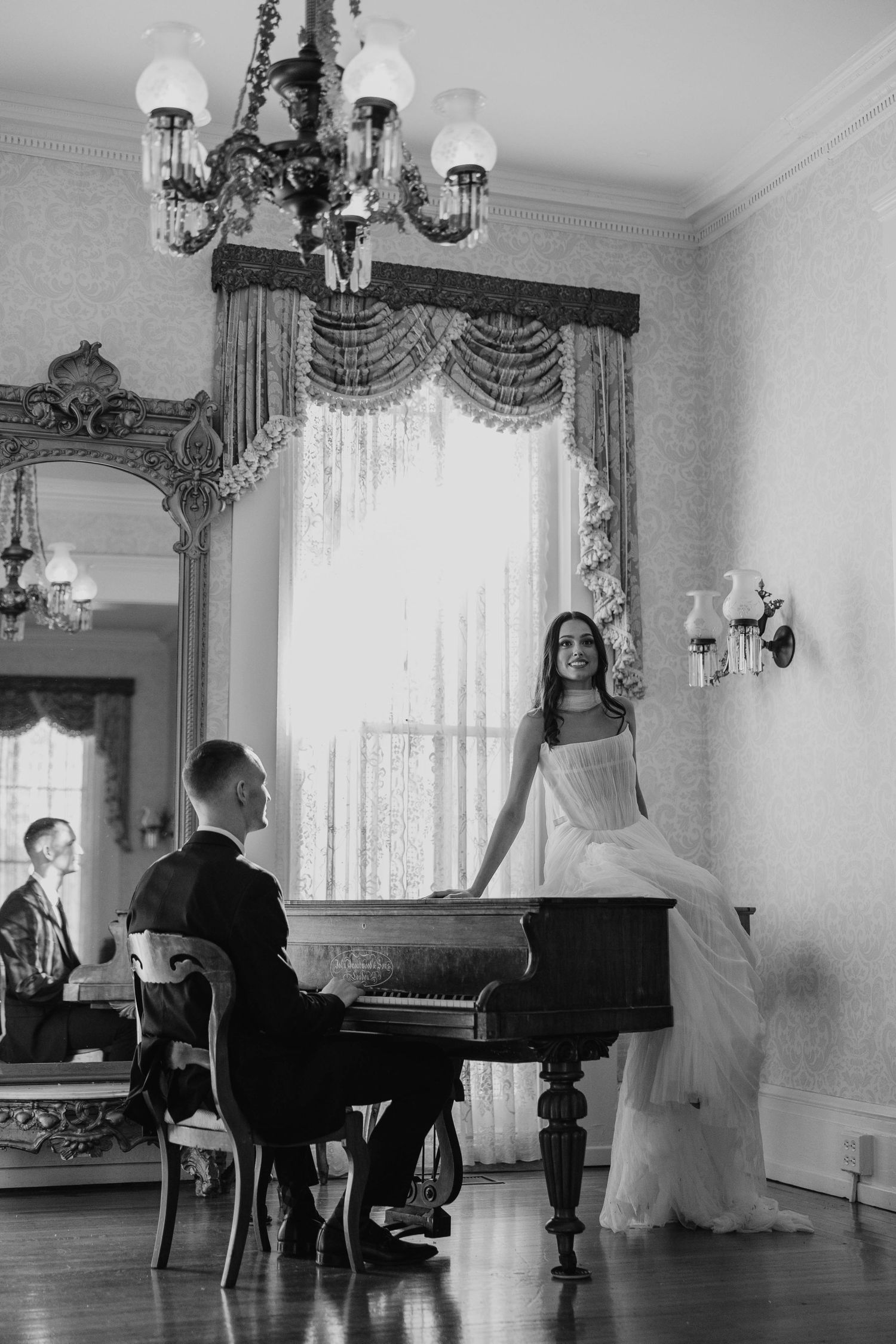 Black and white wedding photos featuring a grand piano in an elegant room with chandeliers.