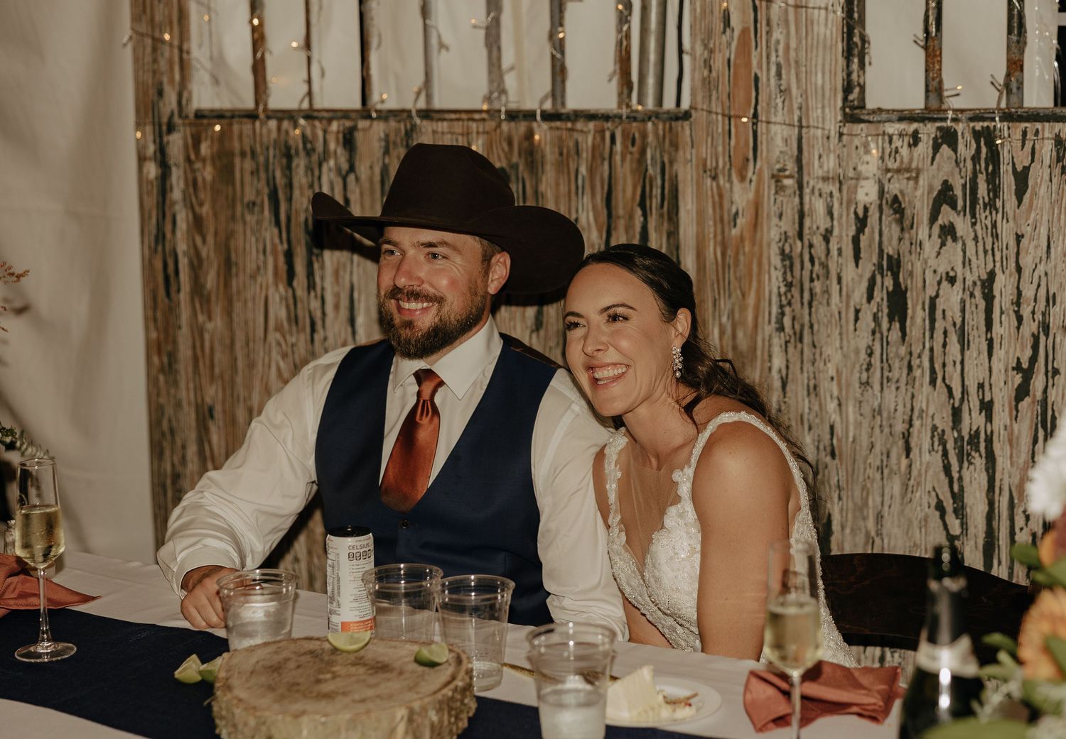 Newlyweds sharing a moment at their rustic barn reception.