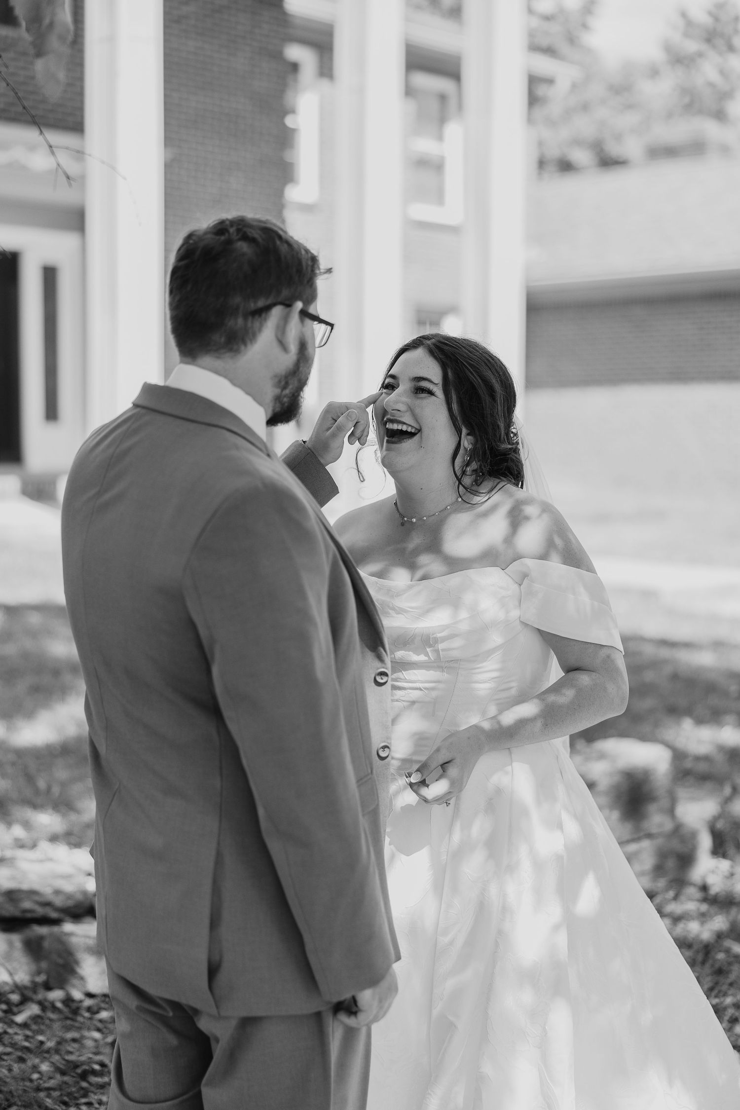 A black and white photo sequence shows a couple sharing their first look moment on their wedding day.