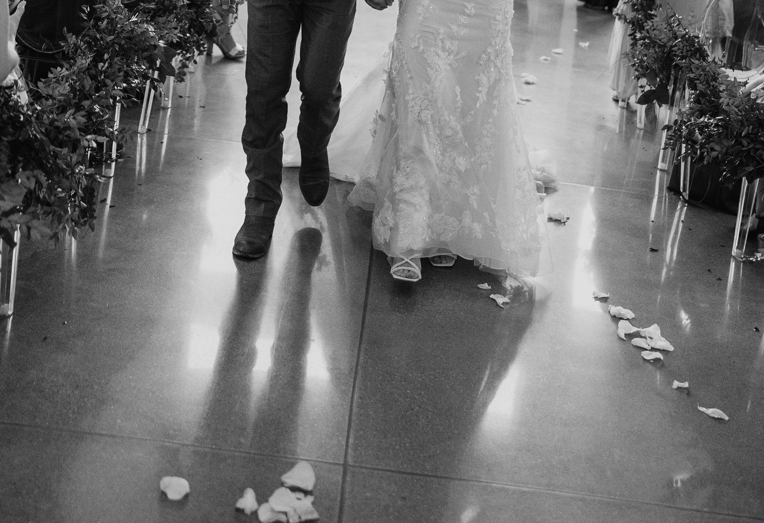 Guests dancing and celebrating at a wedding reception on a polished floor.