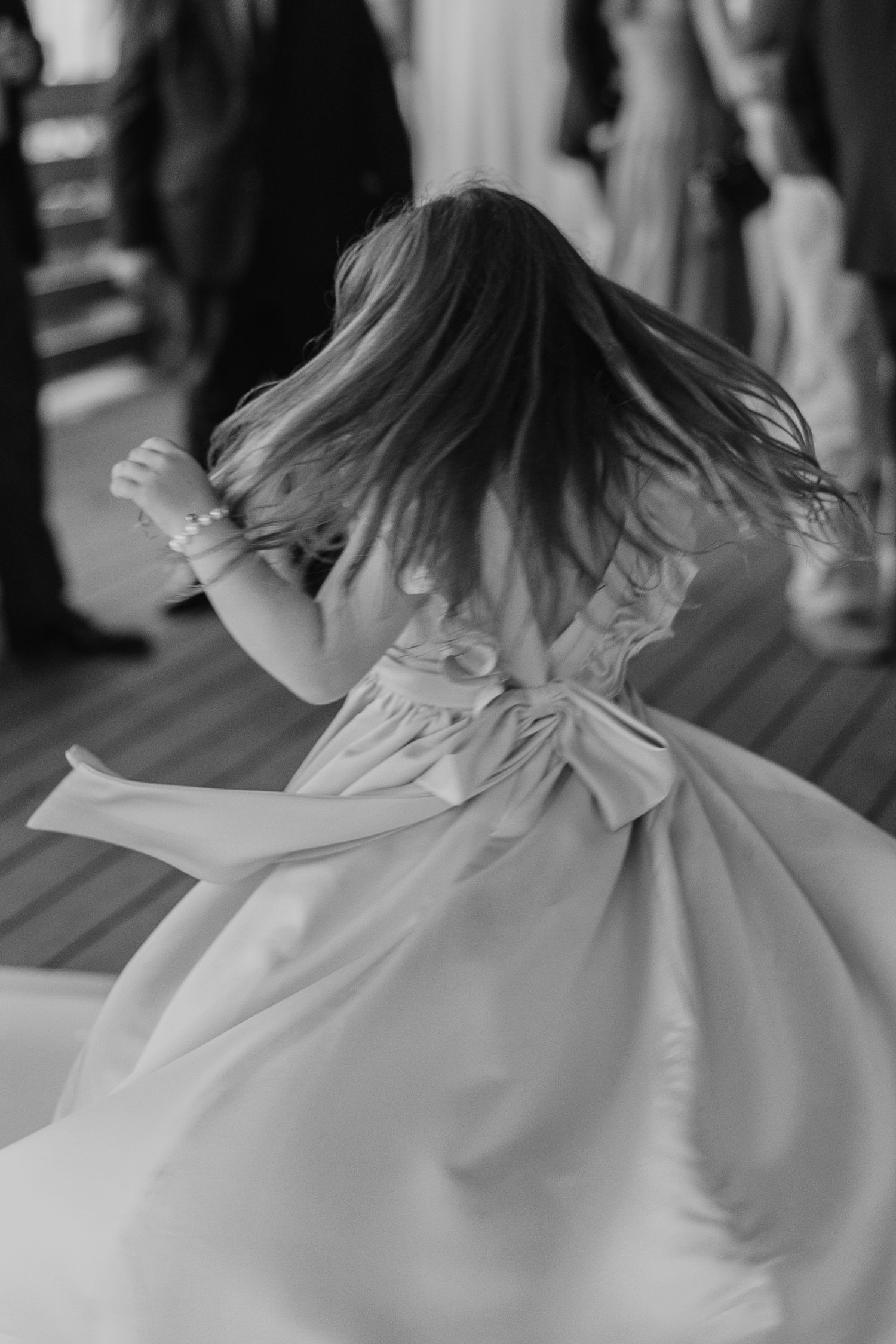 The back of a white dress flows gracefully in black and white photography.