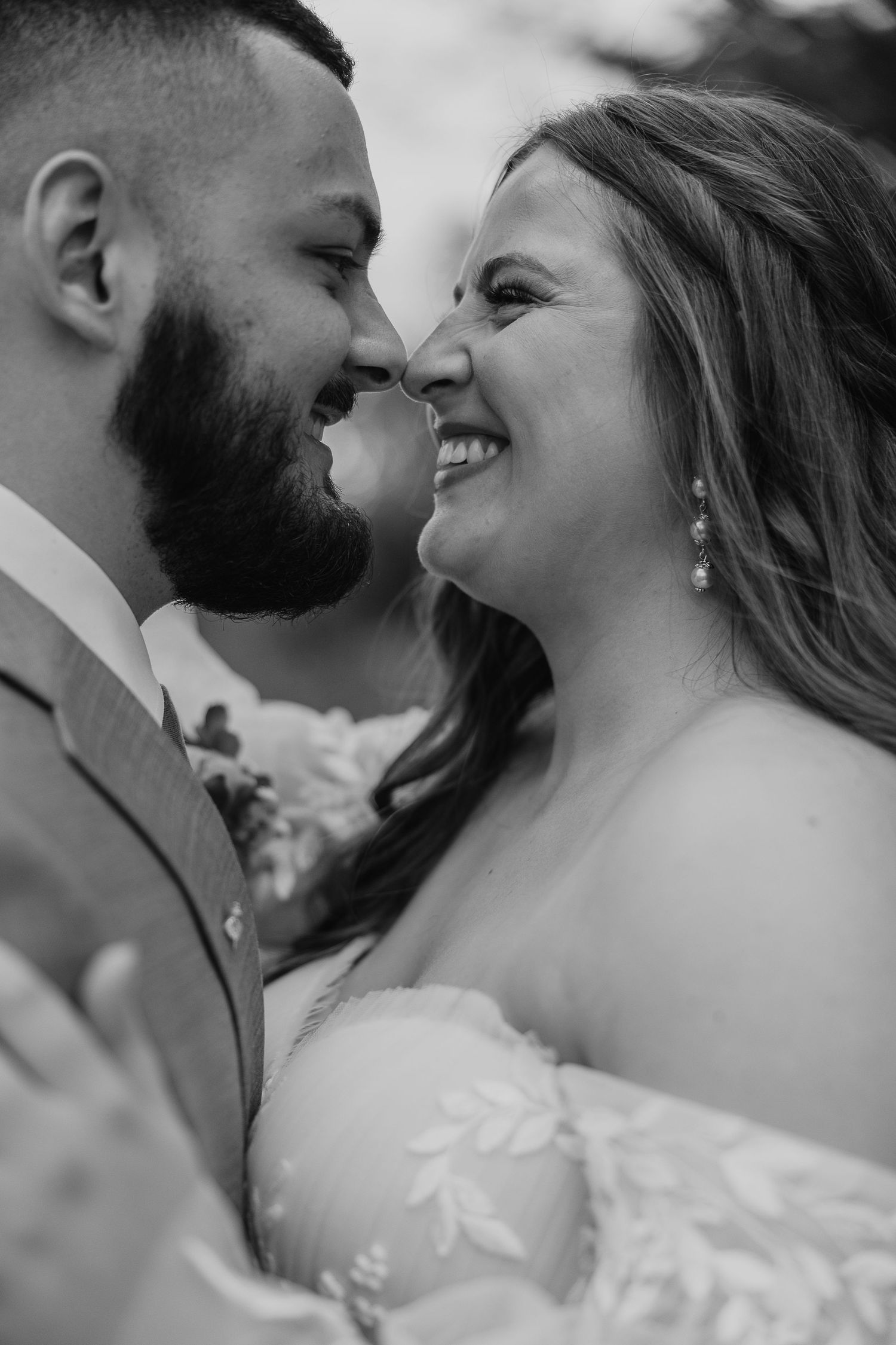 Black and white romantic portrait of newlyweds sharing a tender moment.
