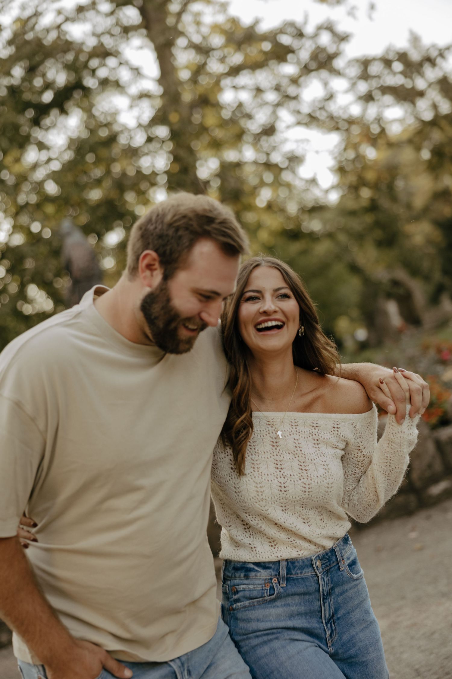 Playful couples portrait session with casual outfits in warm evening light.