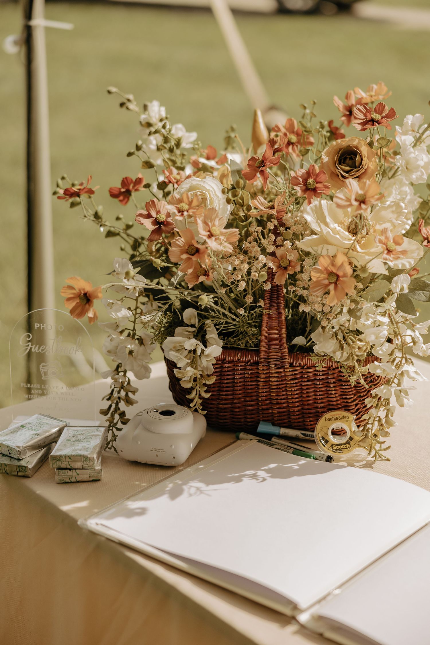 Rustic wicker baskets filled with pink and white flowers arranged on a wooden table.