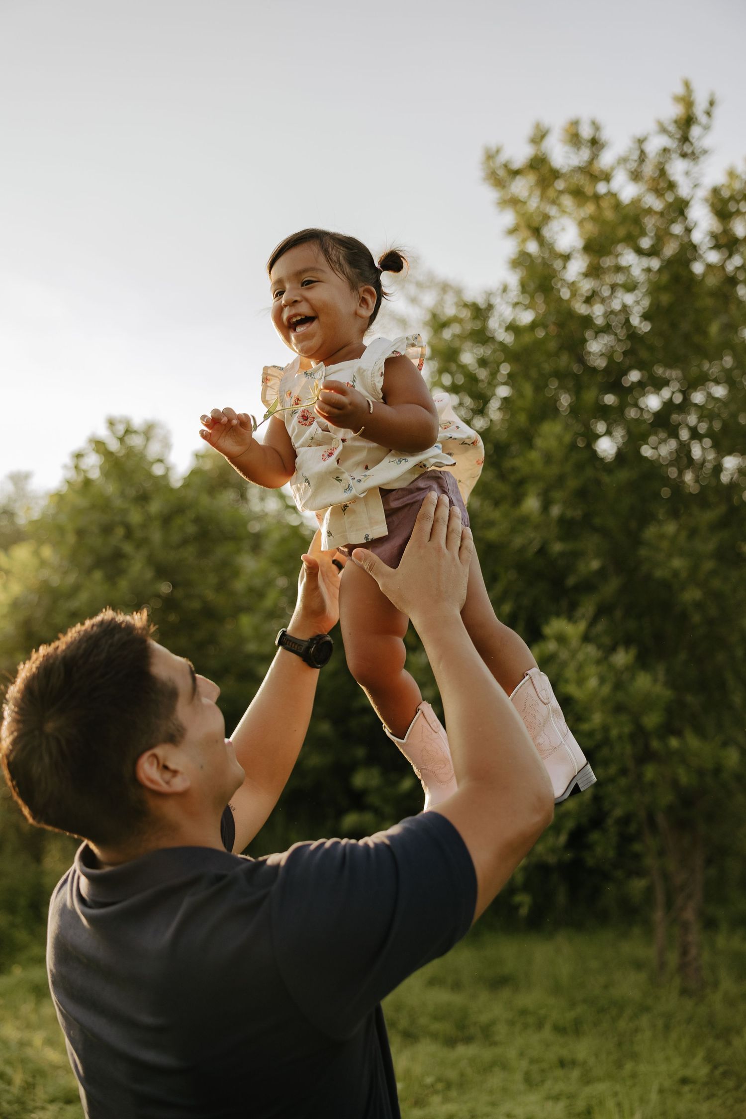 Joyful moment of play in an outdoor setting during sunset.