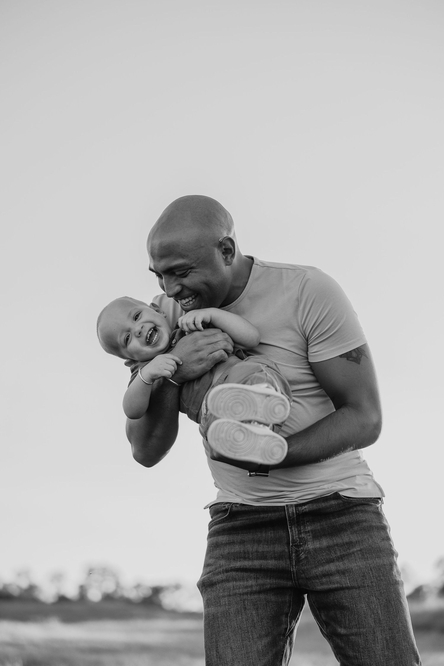 Black and white series of playful moments between parent and baby.