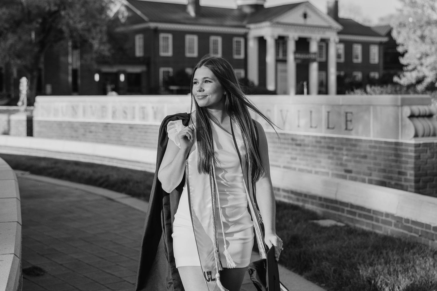 Black and white graduation photos featuring architectural elements and brick buildings.
