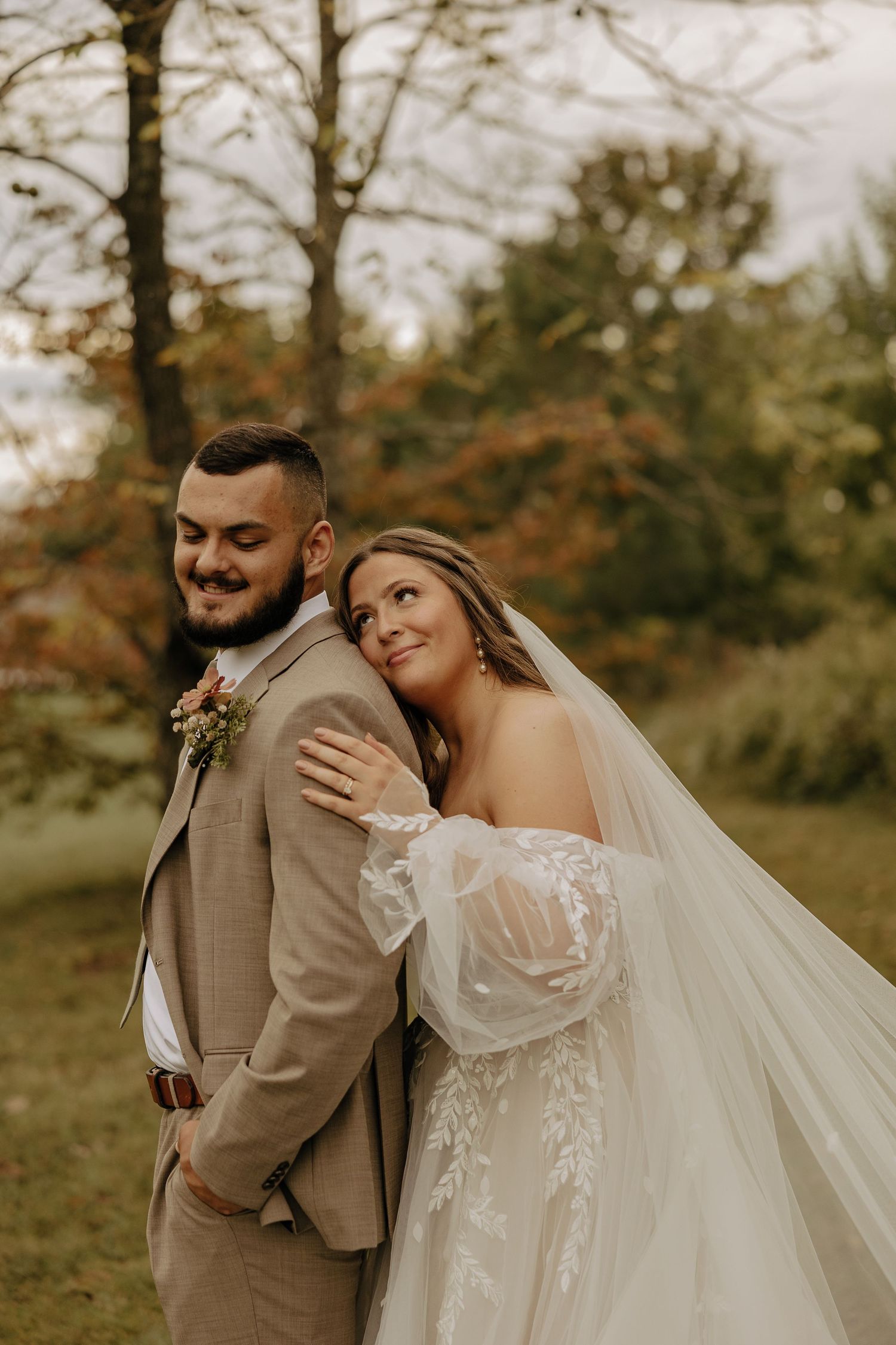 A romantic autumn wedding photo series showing tender moments between newlyweds in a natural outdoor setting.