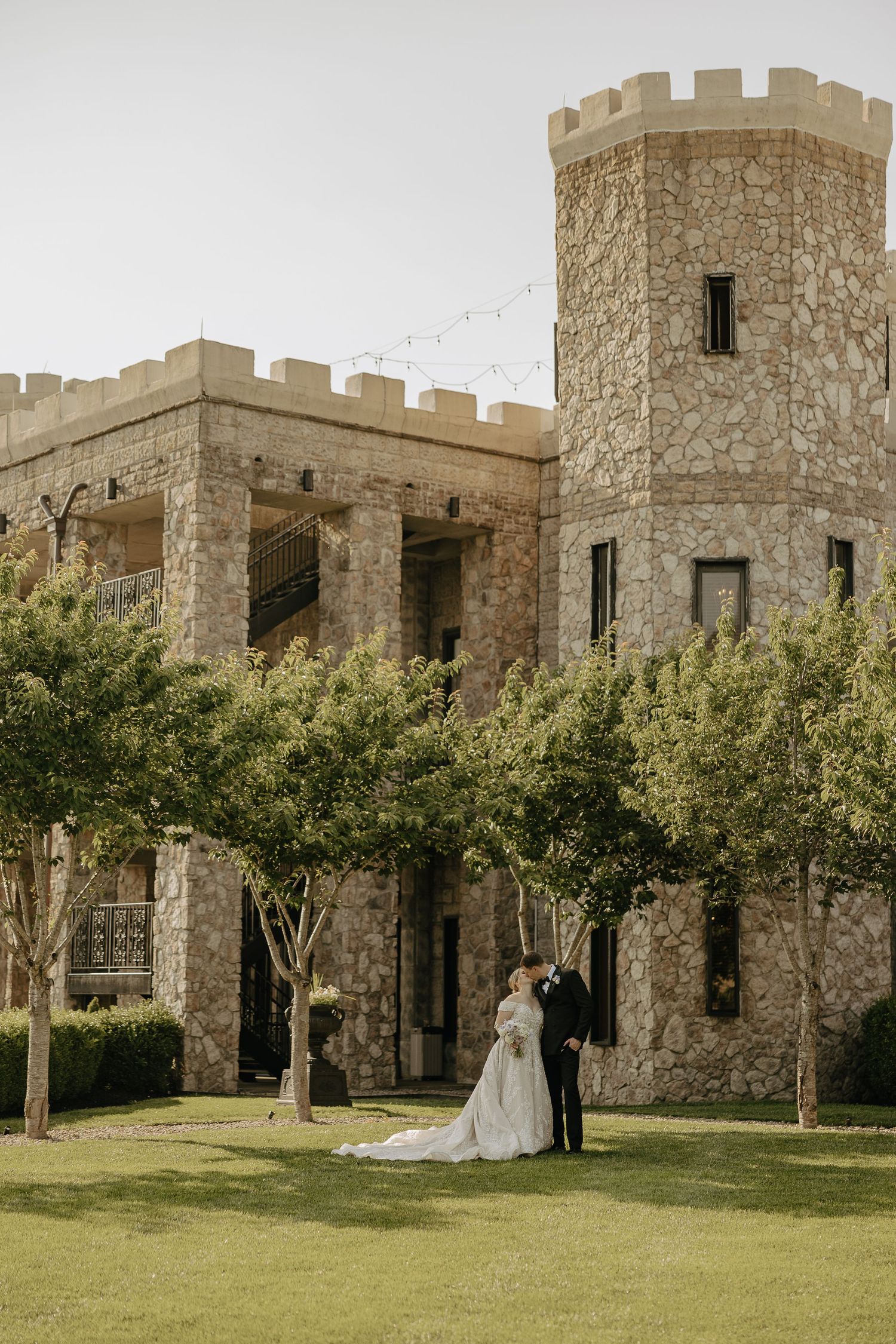 Castle-style wedding venue with stone walls and manicured gardens.