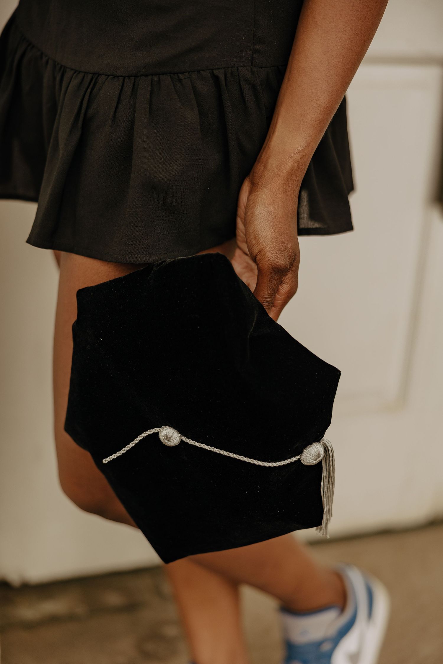 Close-up view of black shorts with white trim detail against a neutral background.