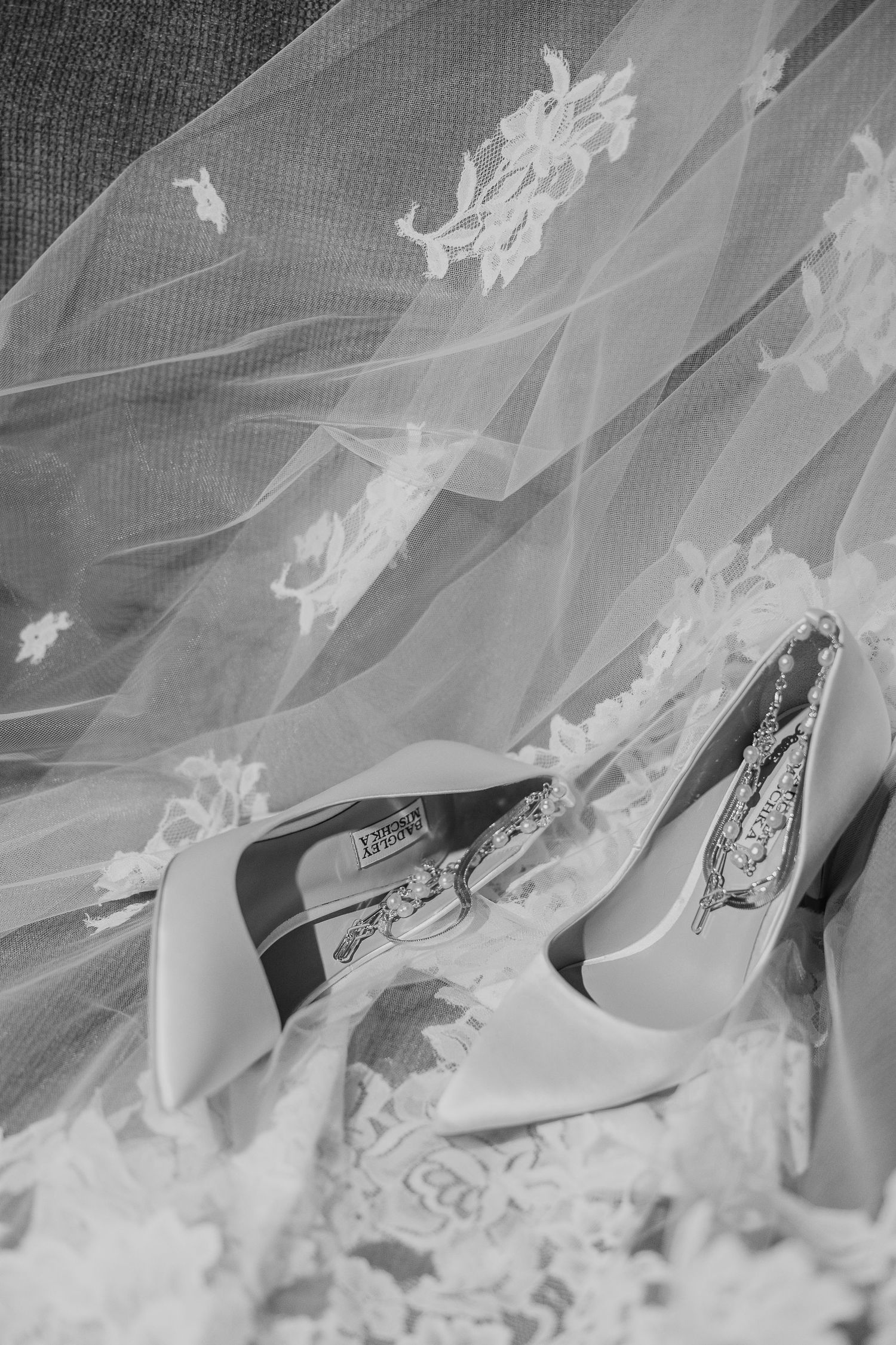 Delicate lace details of a wedding veil with embroidered floral patterns.