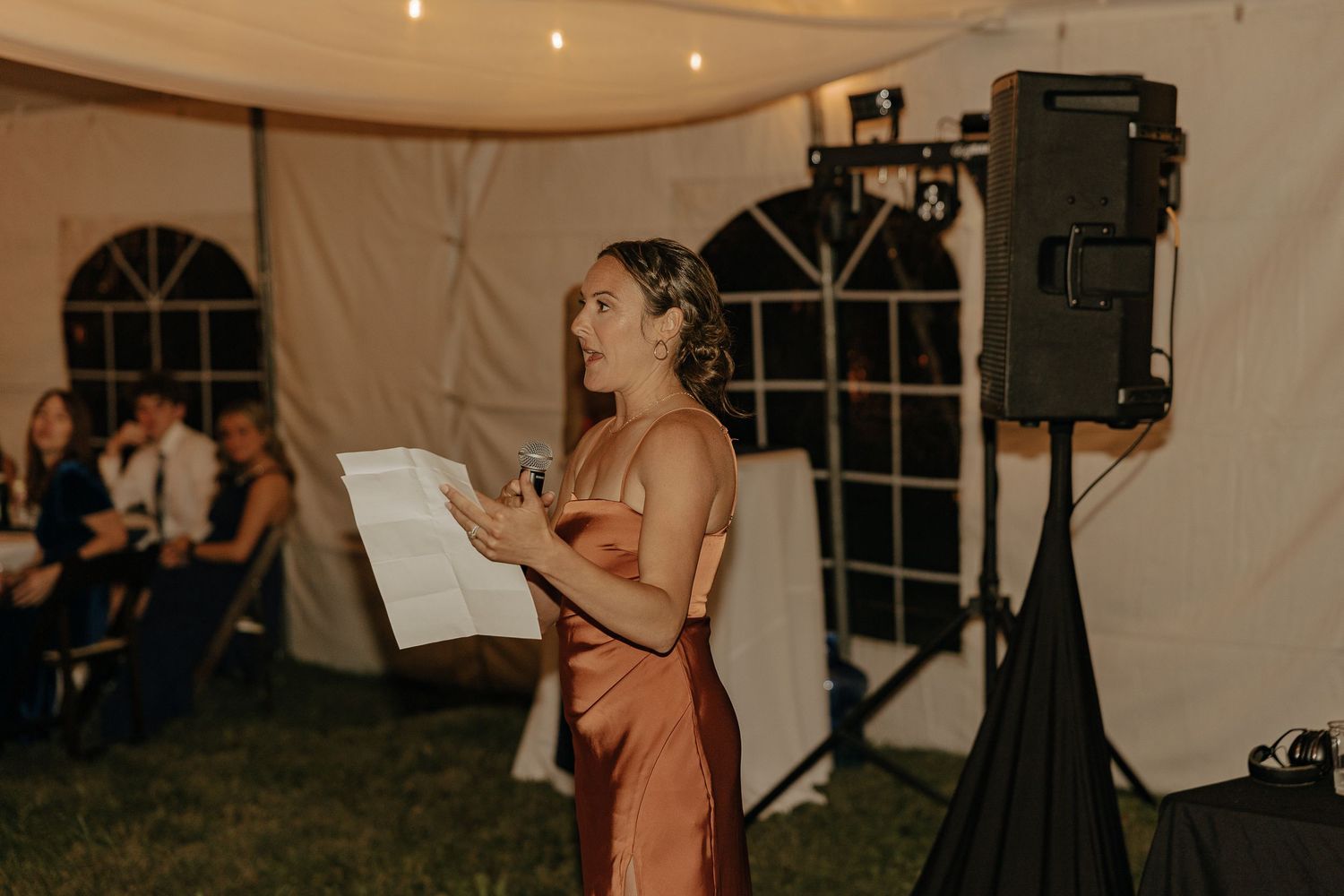 Wedding reception tent setup with string lights and elegant decor creating a romantic atmosphere.