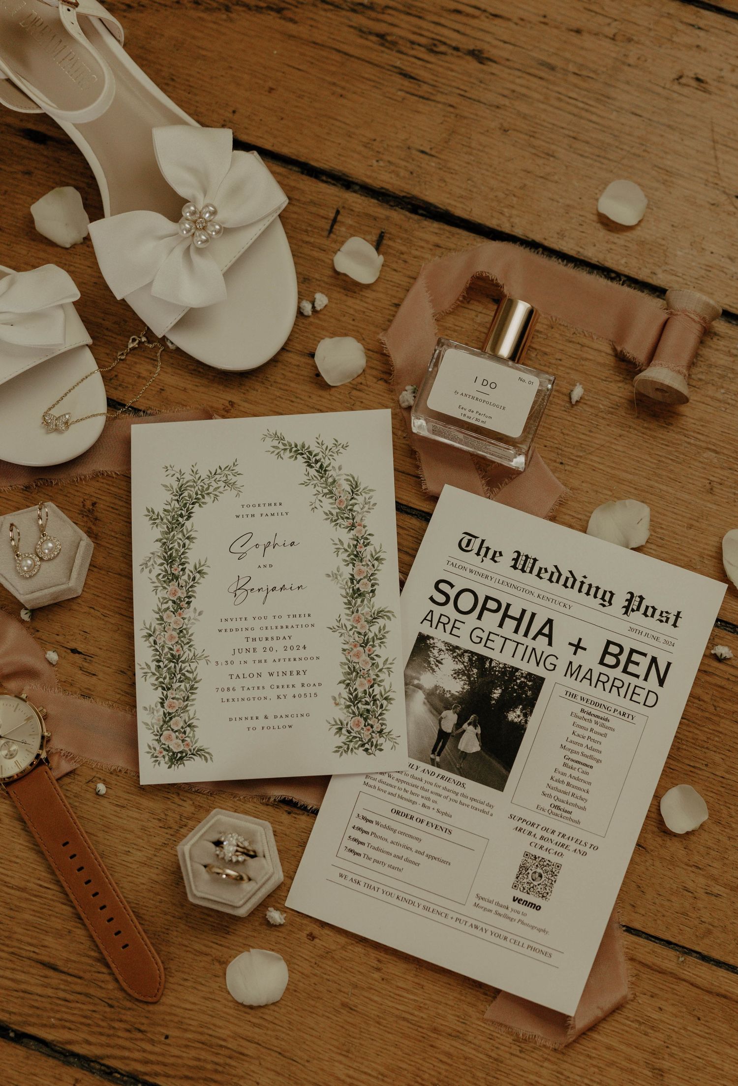 Elegant wedding stationery and invitations with floral designs displayed on rustic wooden surface.