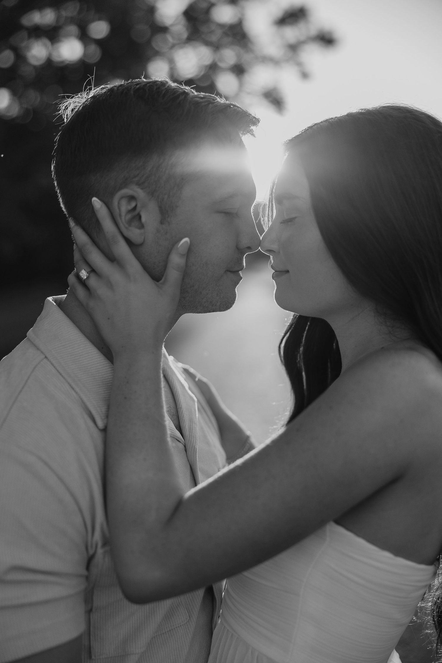 An intimate black and white photo series of a couple sharing tender moments at sunset.