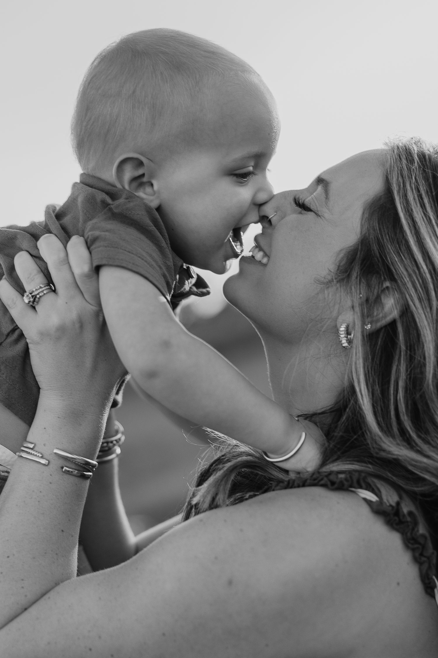Close-up black and white shots of tender family moments.