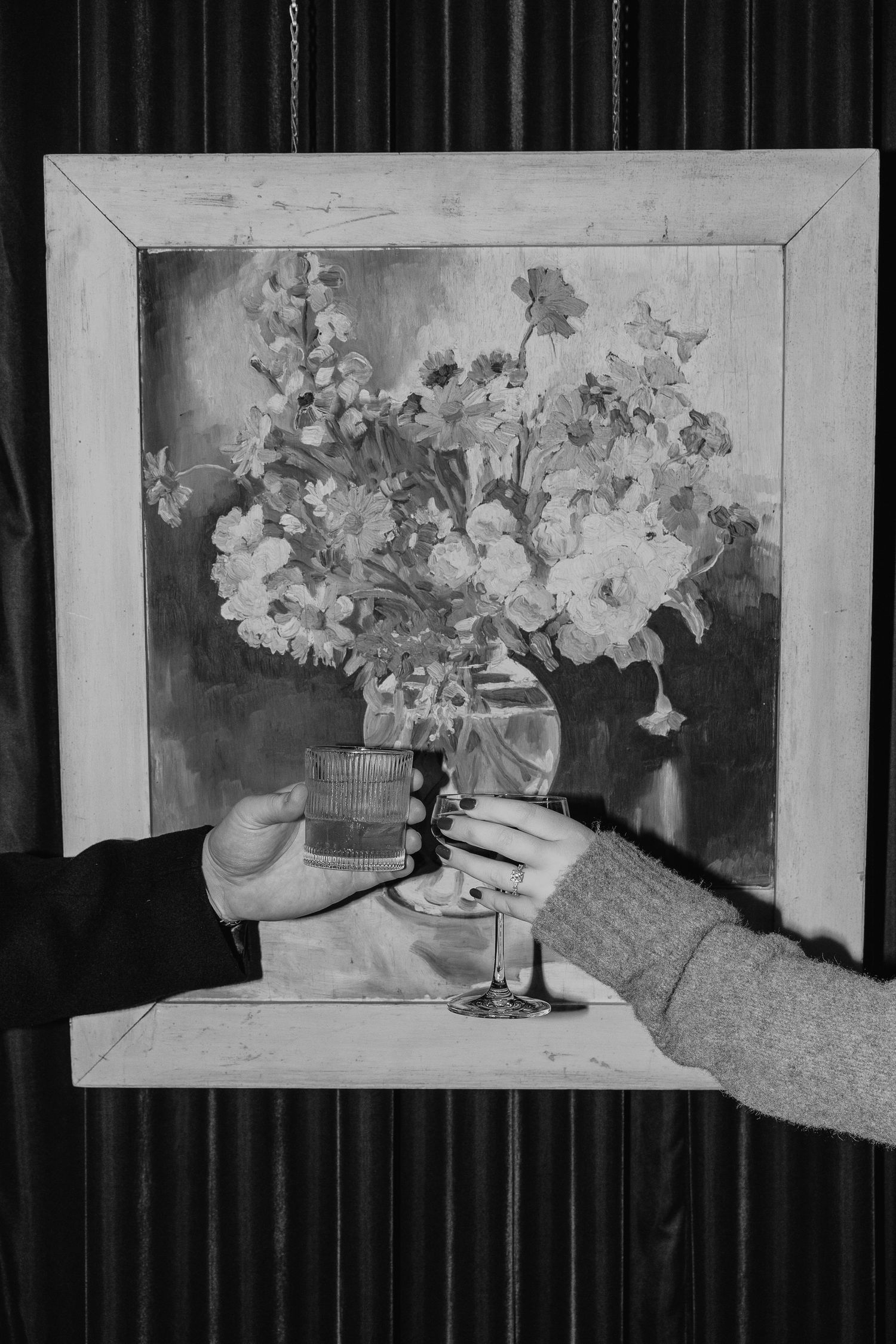 Black and white floral still life artwork displayed in sequence on a wall.