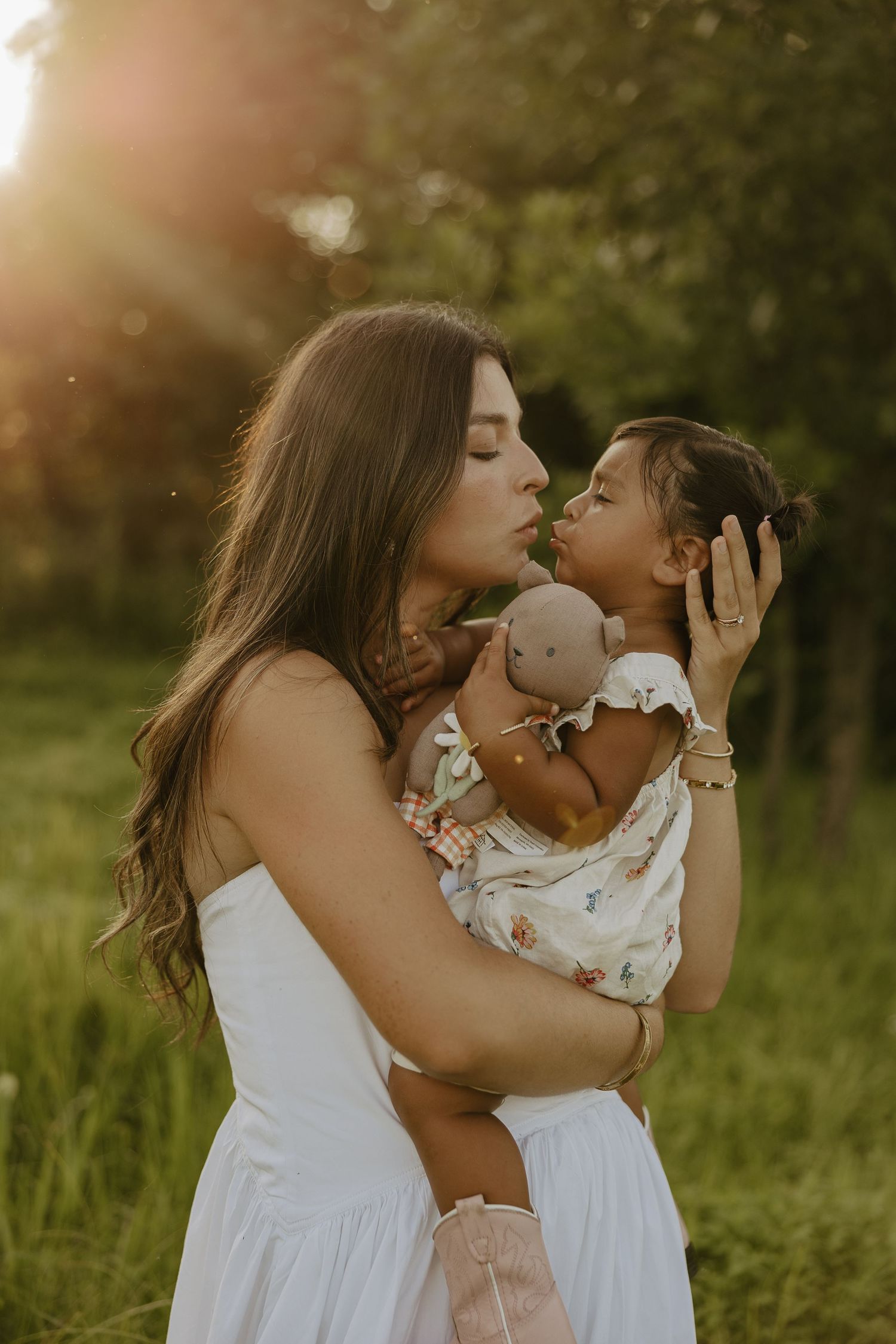 Sweet embraces shared in a sun-drenched field.