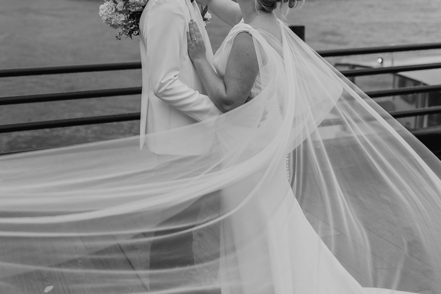 Flowing wedding veil movement captured in black and white photography.