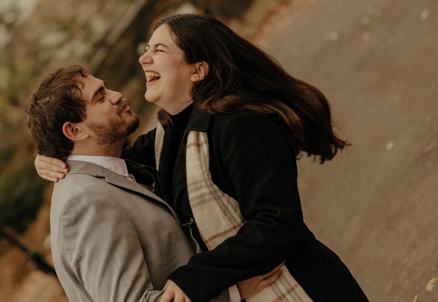 A romantic couple embraces and shares intimate moments in a series of warm-toned outdoor photographs.