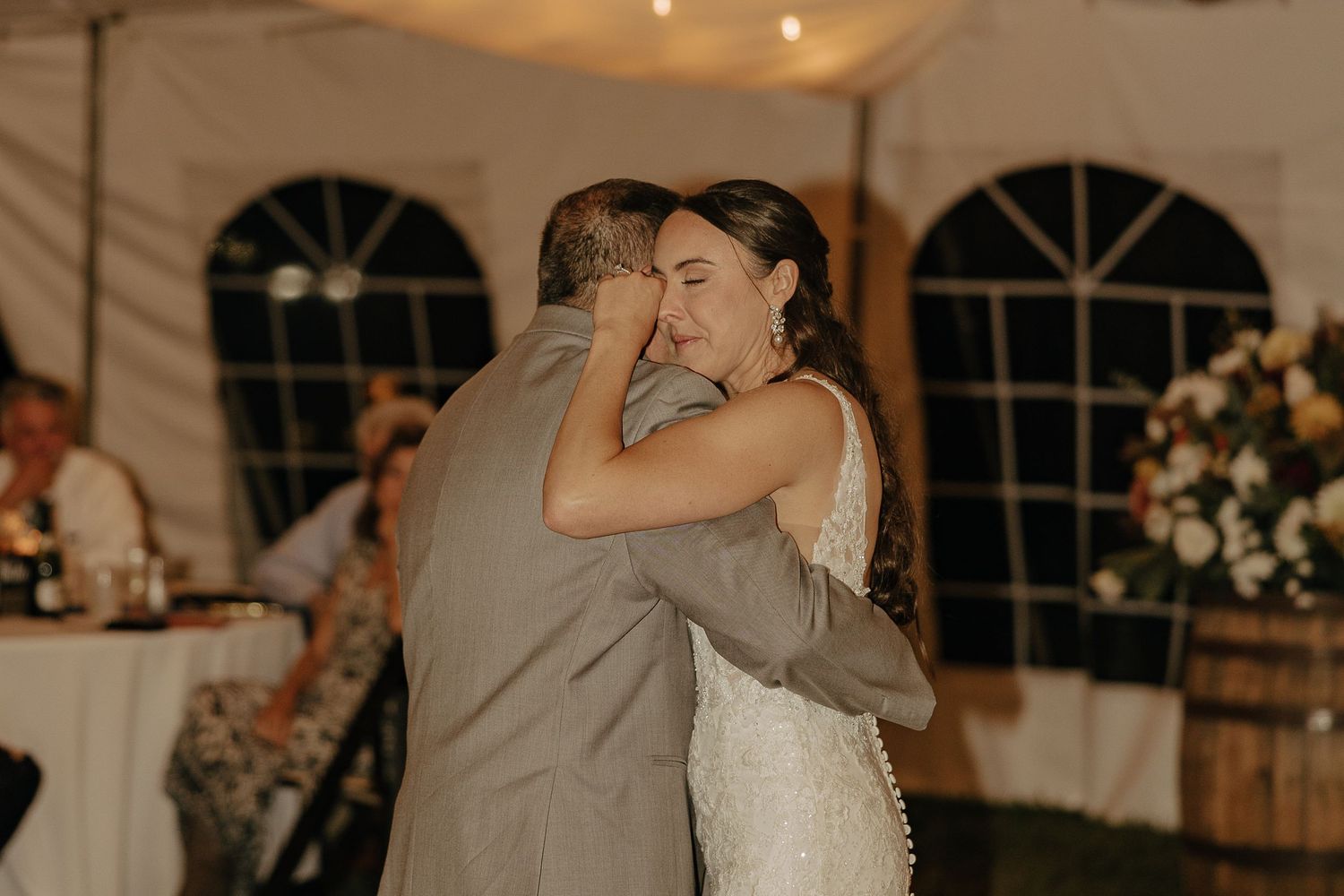 Intimate dance moment captured during reception under warm lighting.