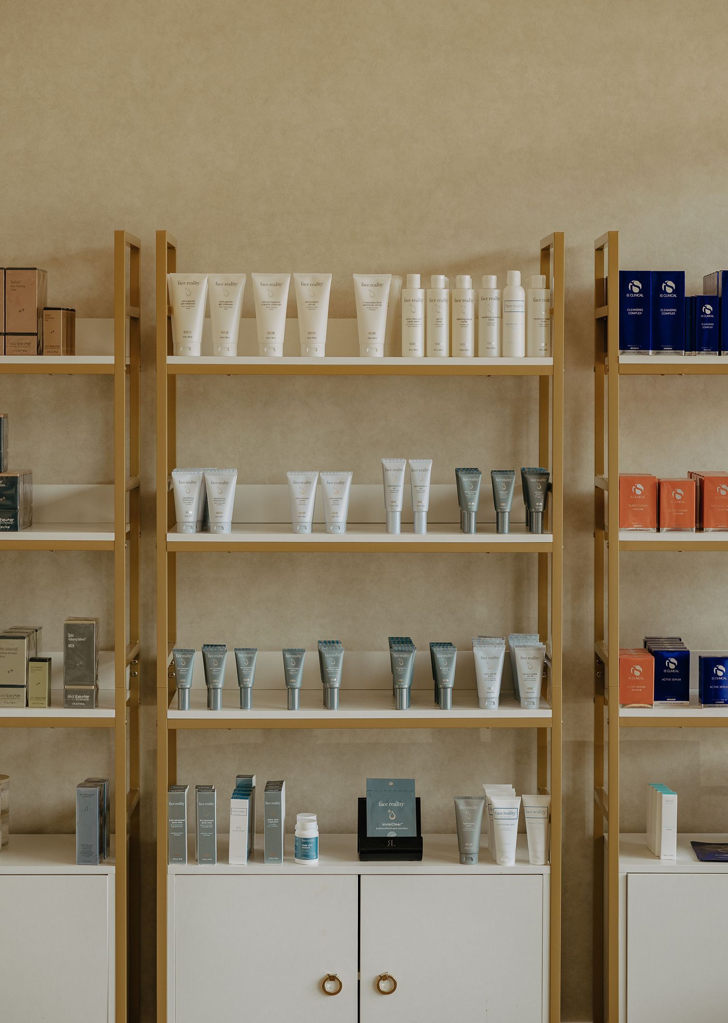 Modern retail display with wooden shelving units showcasing beauty products and white packaging.