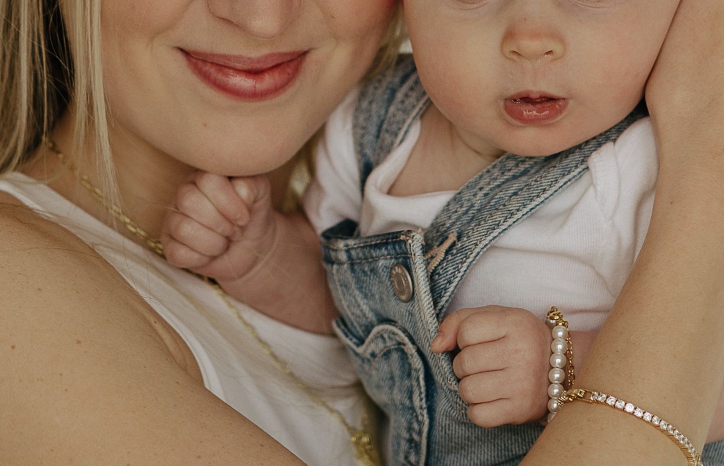 Close-up shots showing tender interactions and pearl accessories against a neutral background.