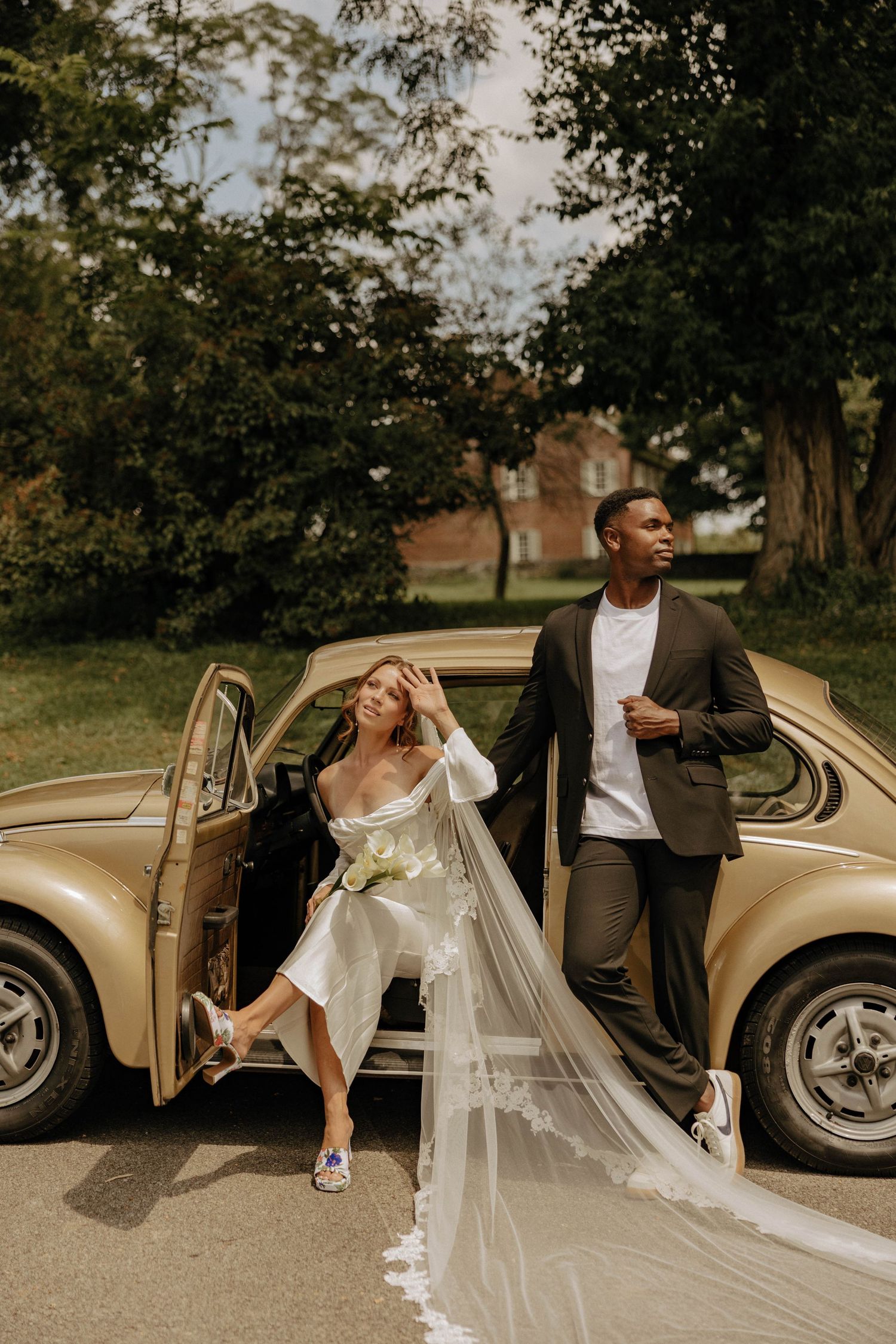 A sequence of romantic wedding photos showing a couple posing with a vintage car in a natural outdoor setting.