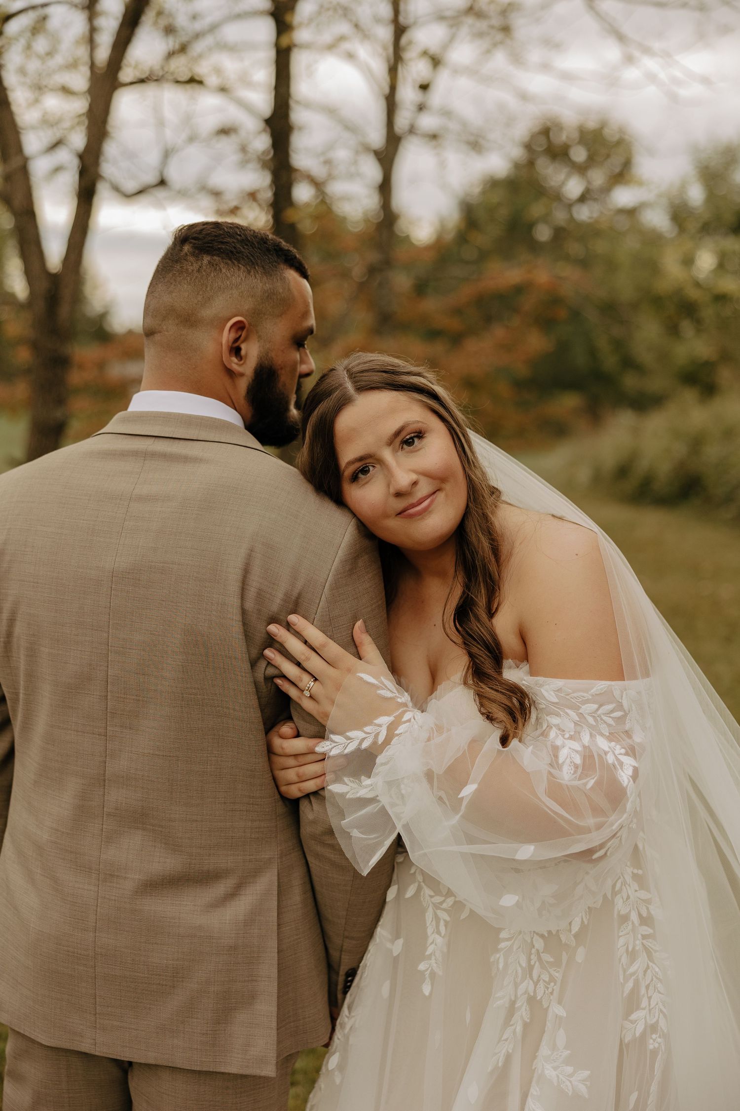 A romantic wedding portrait moment captured in warm autumn light.