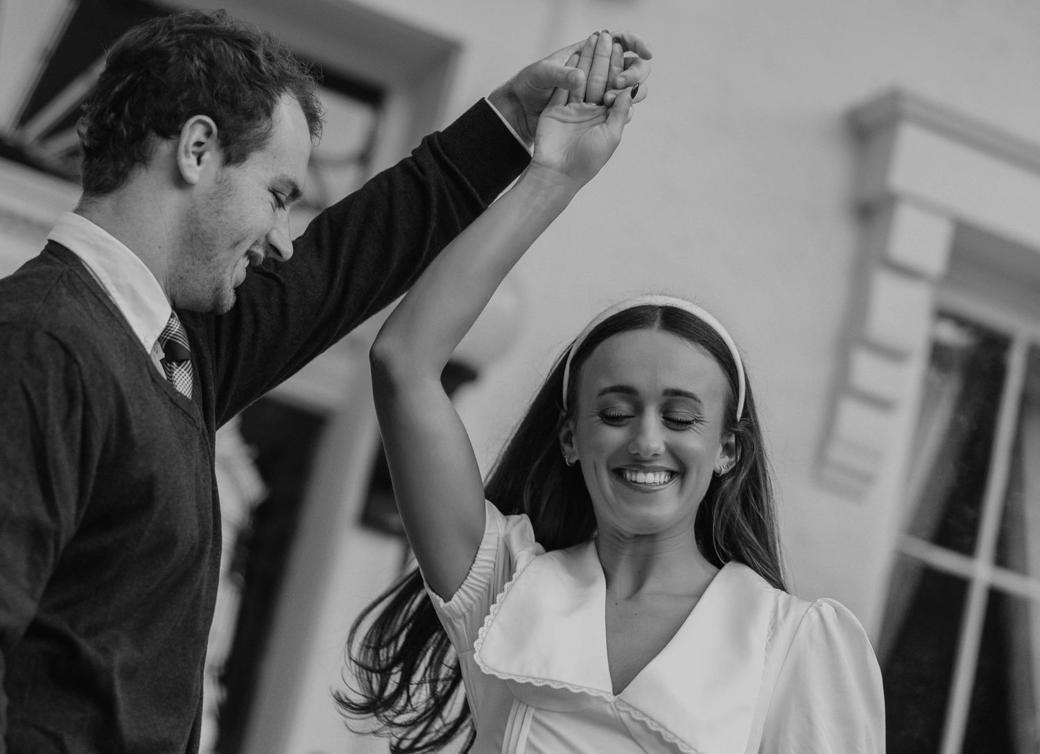 Black and white sequence of a couple dancing and twirling together.