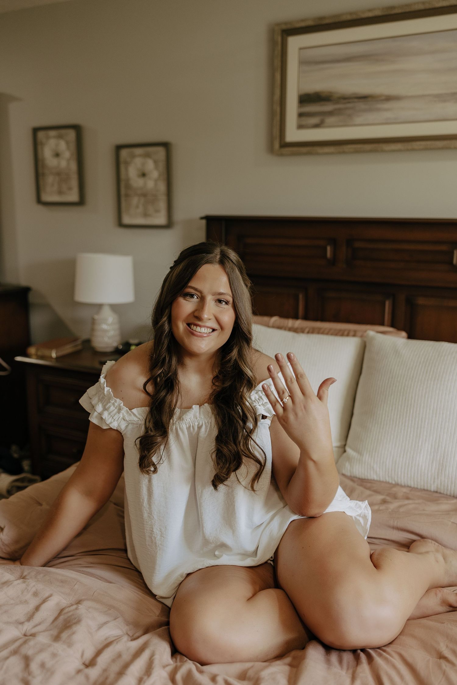 Candid moments of friends relaxing on a bed with white bedding and wooden headboard.