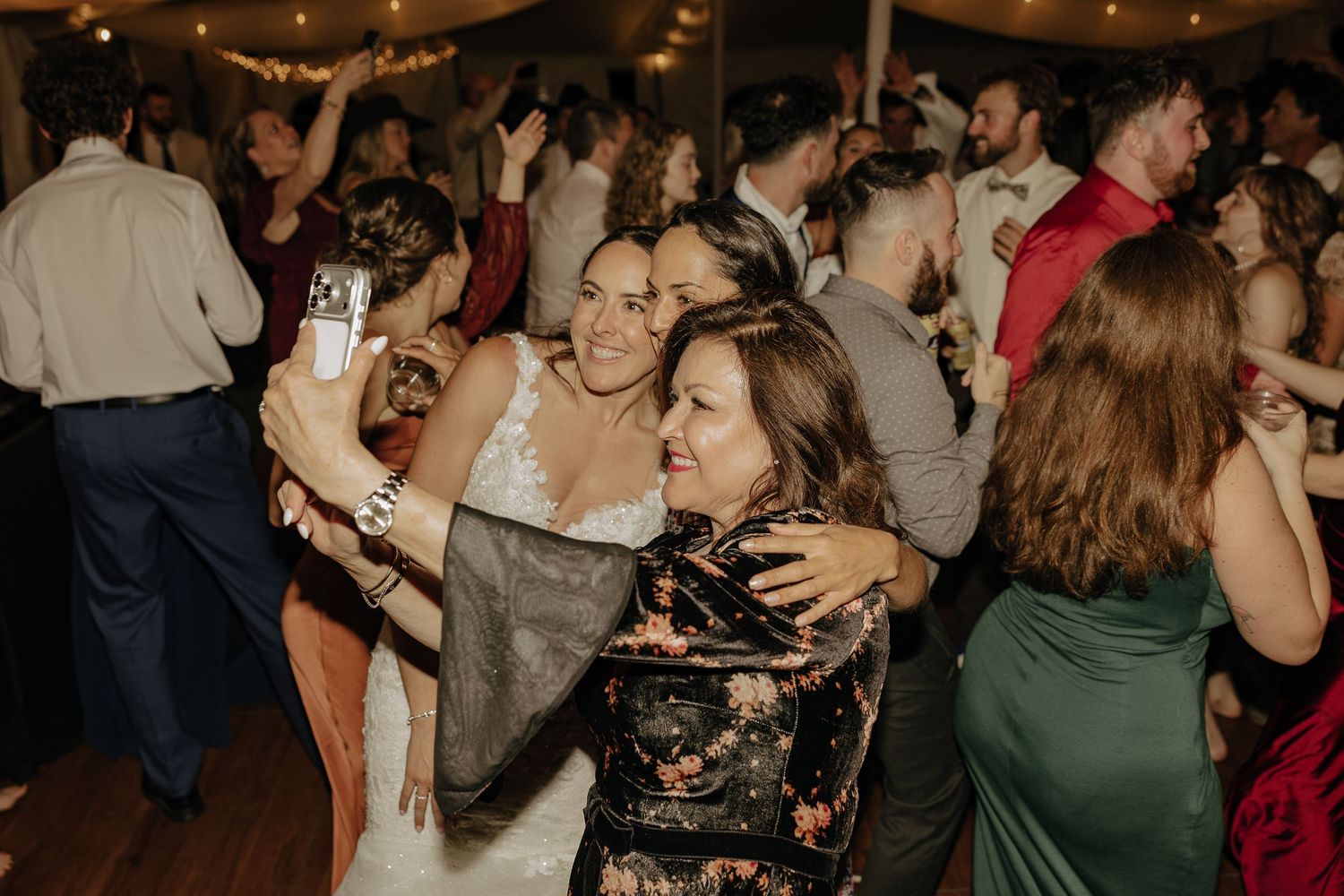 Lively dance floor scene at a wedding reception with guests enjoying the celebration.