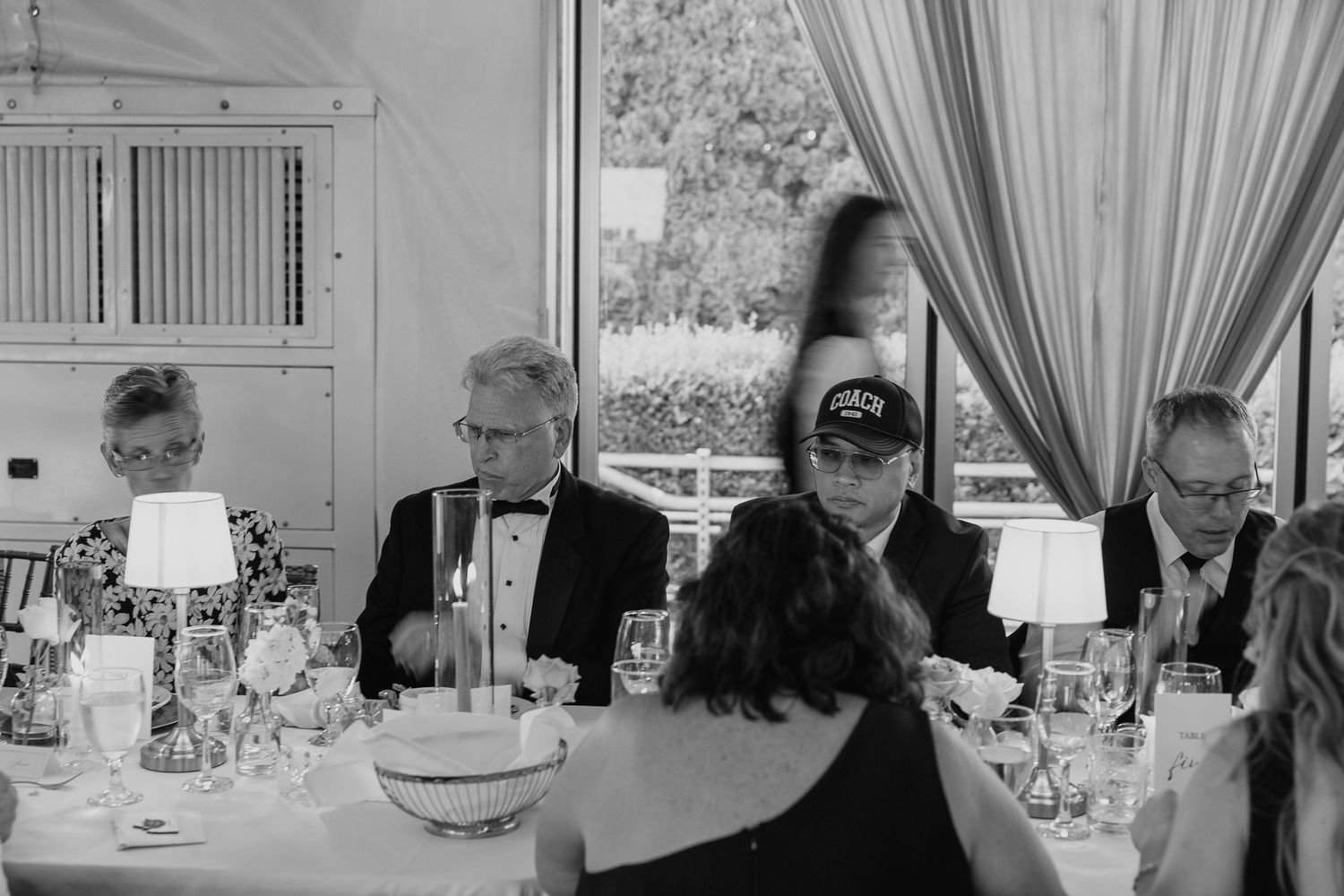 A wedding reception venue with elegant draping and soft lighting.