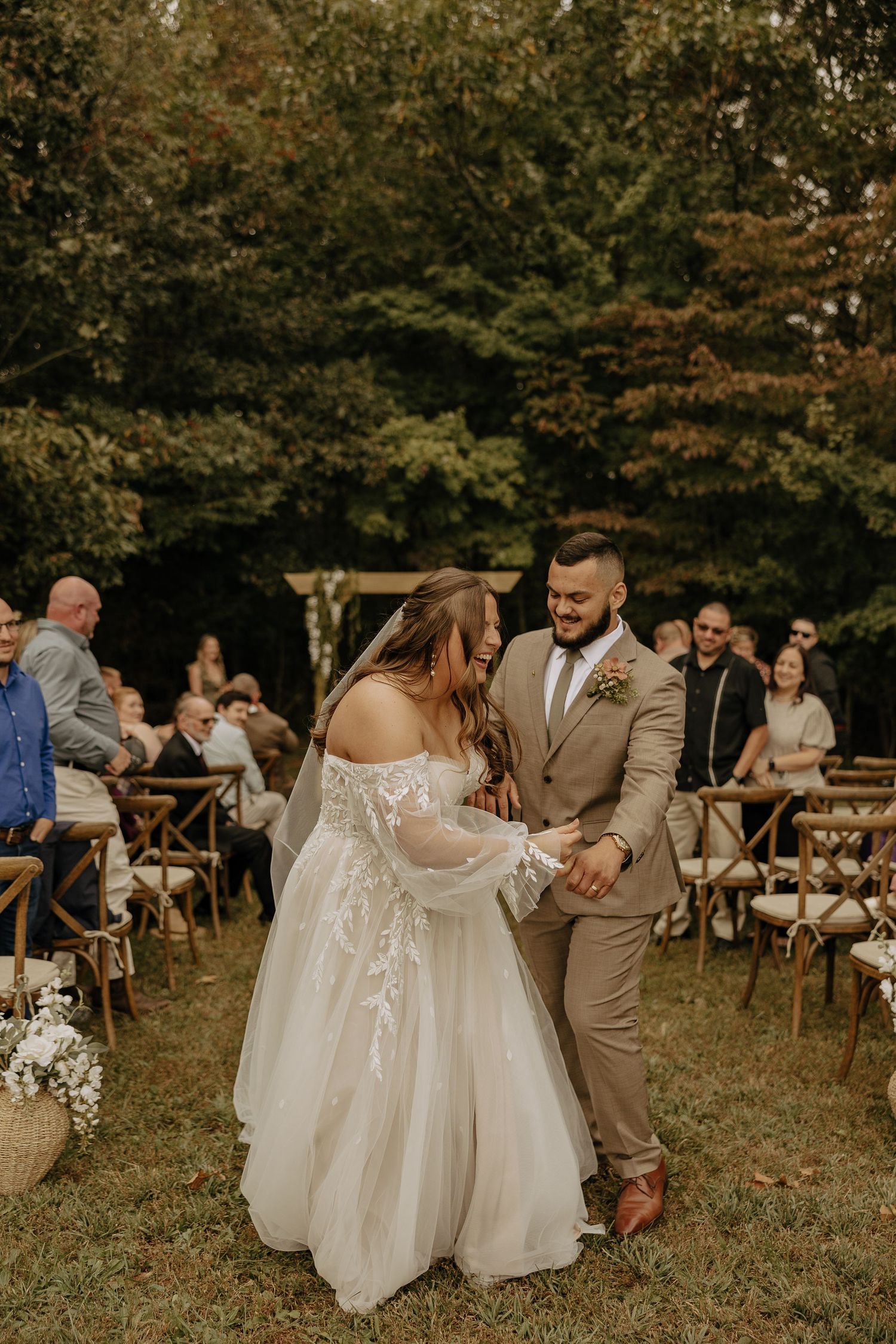 Couple sharing intimate moment during outdoor wedding celebration.