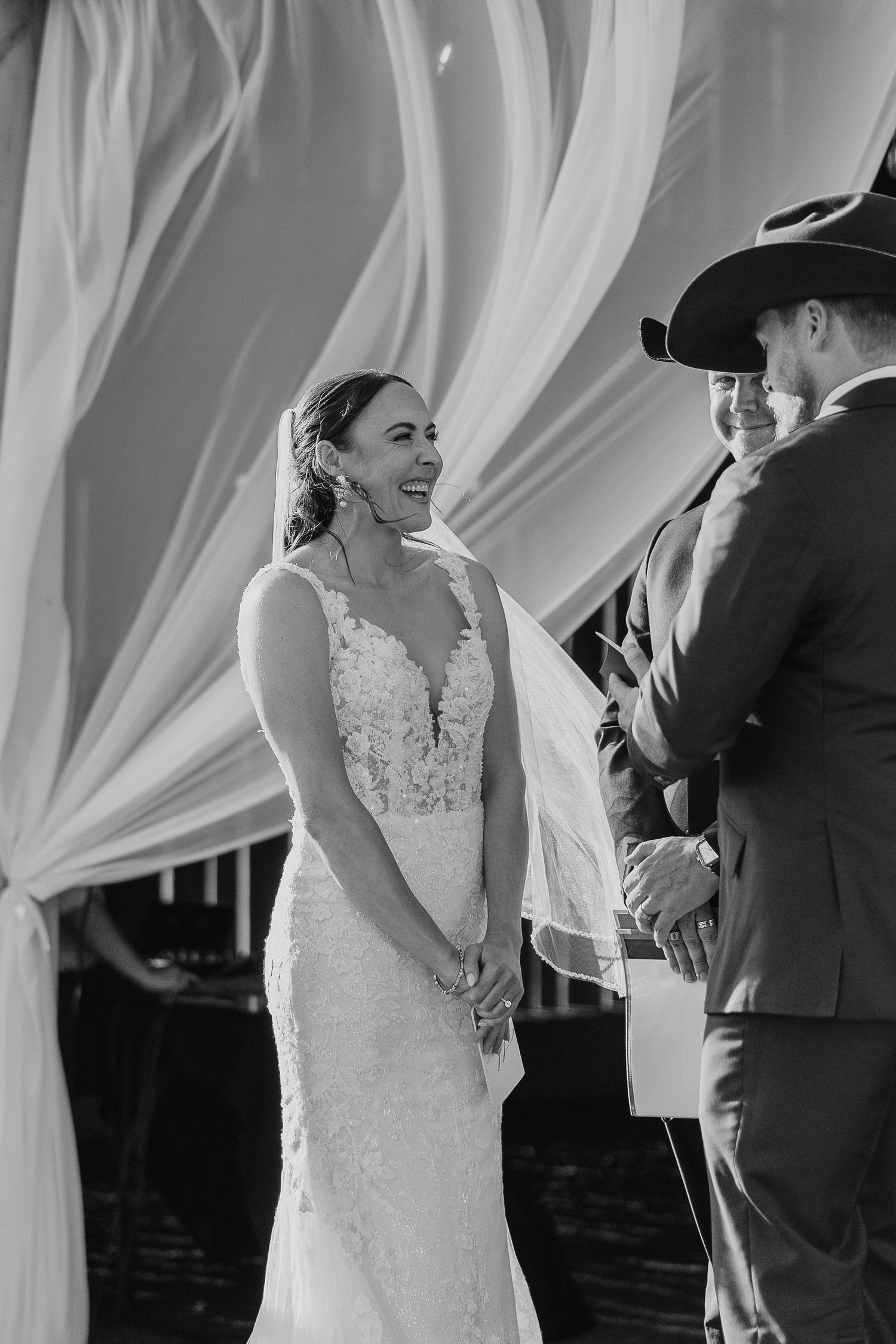 Intimate wedding ceremony moments with white drapery and elegant decor.