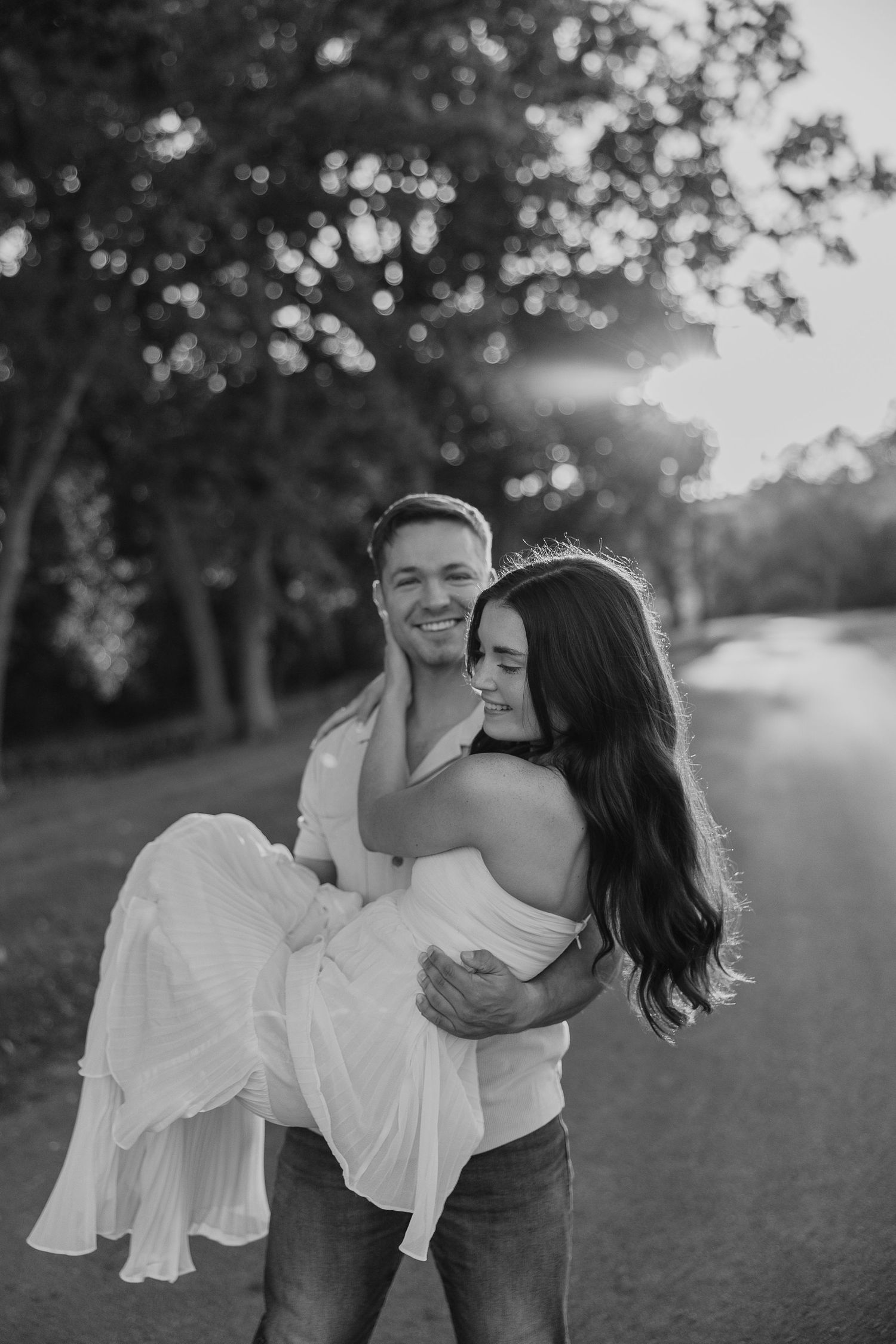 Black and white outdoor portrait series showing playful romantic moments.