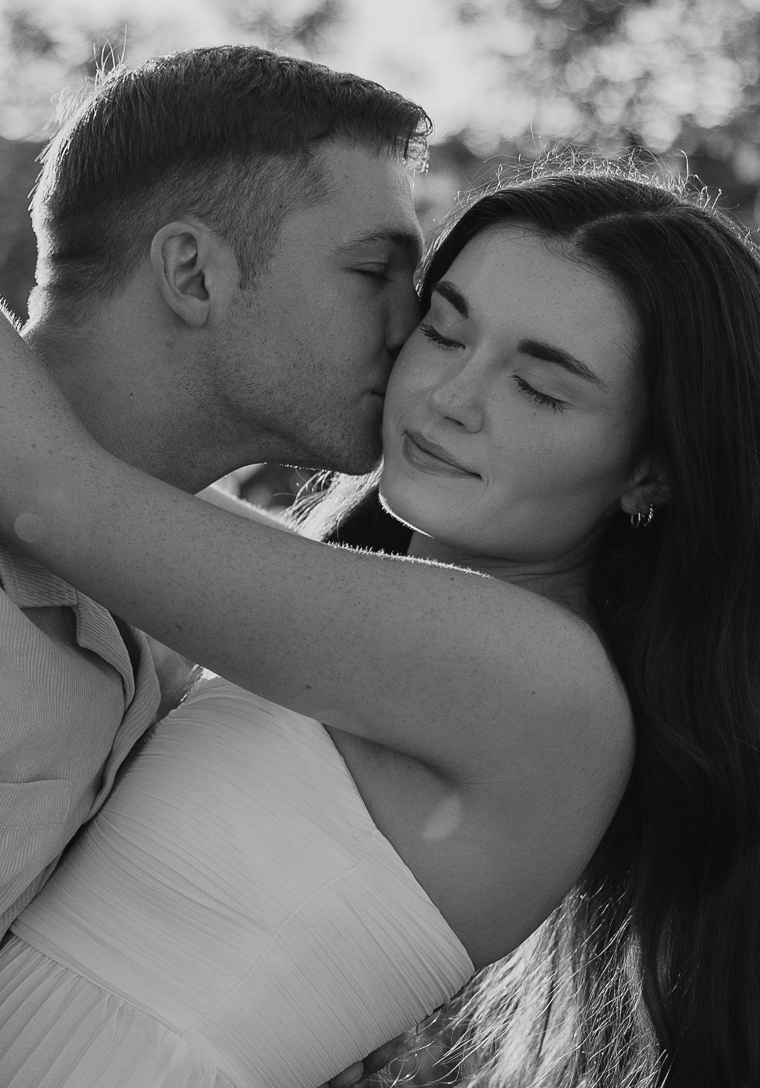 Intimate black and white portrait capturing tender romantic moment.