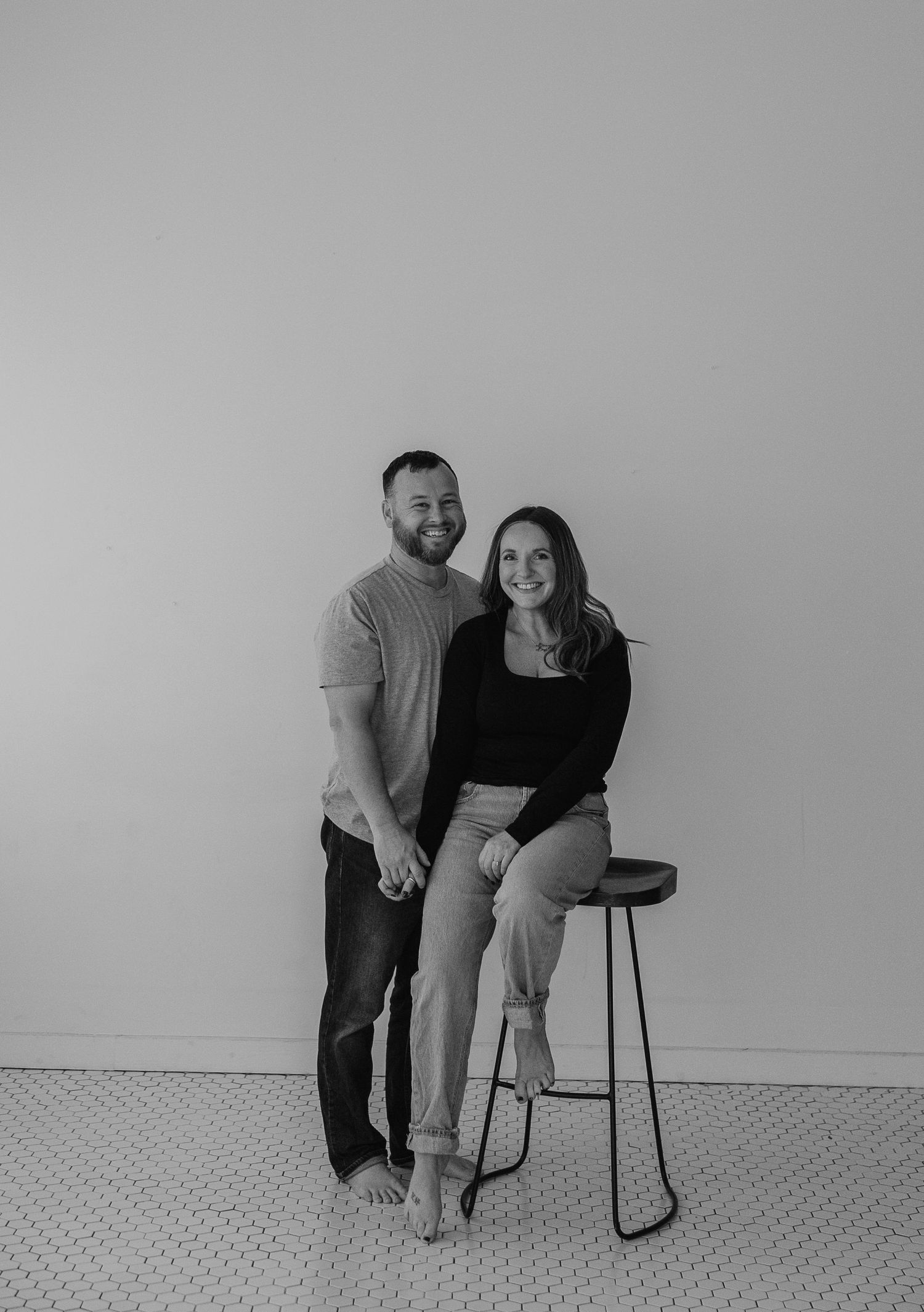 Black and white photo sequence showing figures in minimalist setting demonstrating progressive movement and interaction.