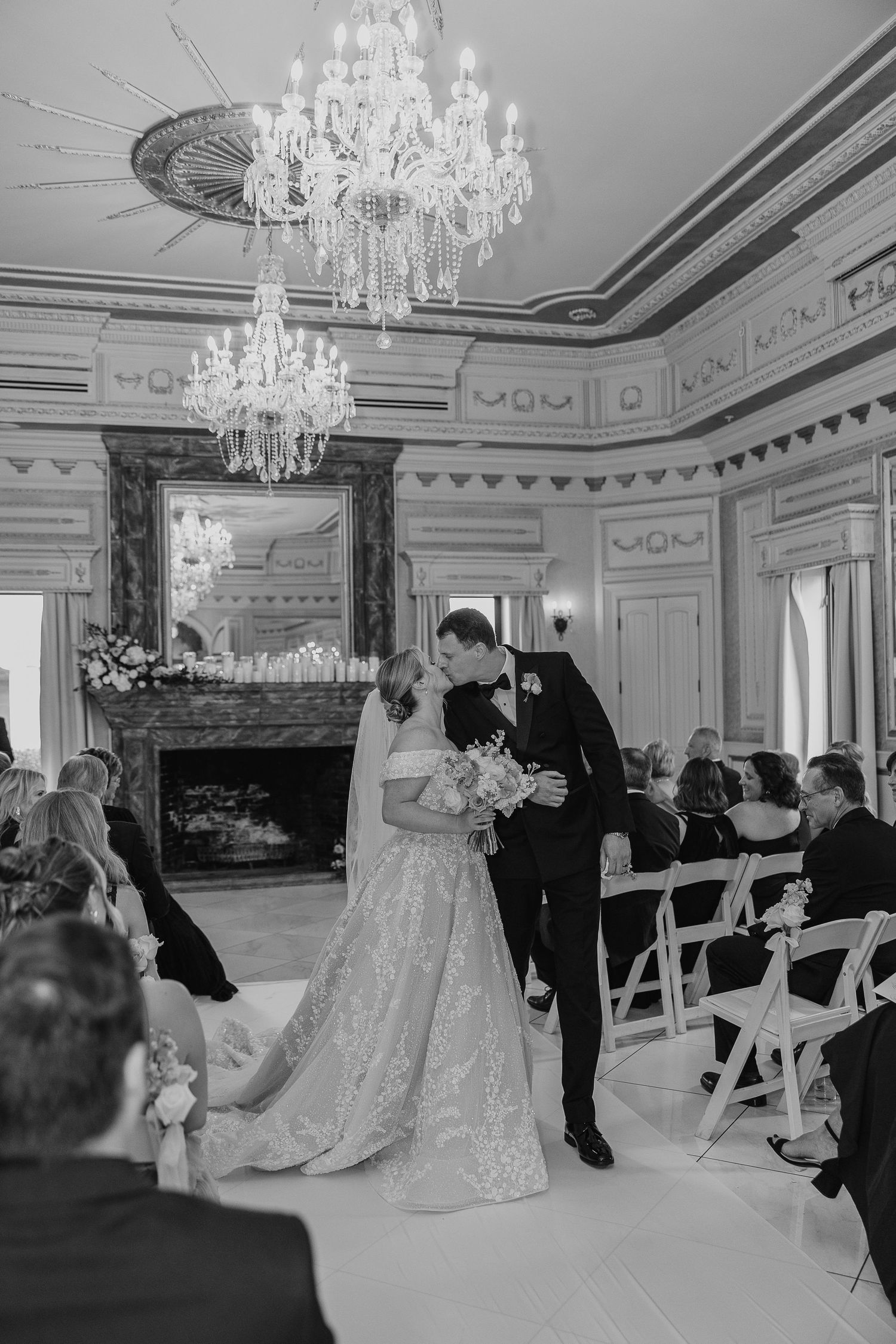 Ornate ballroom ceremony space with crystal chandeliers and elegant architectural details.