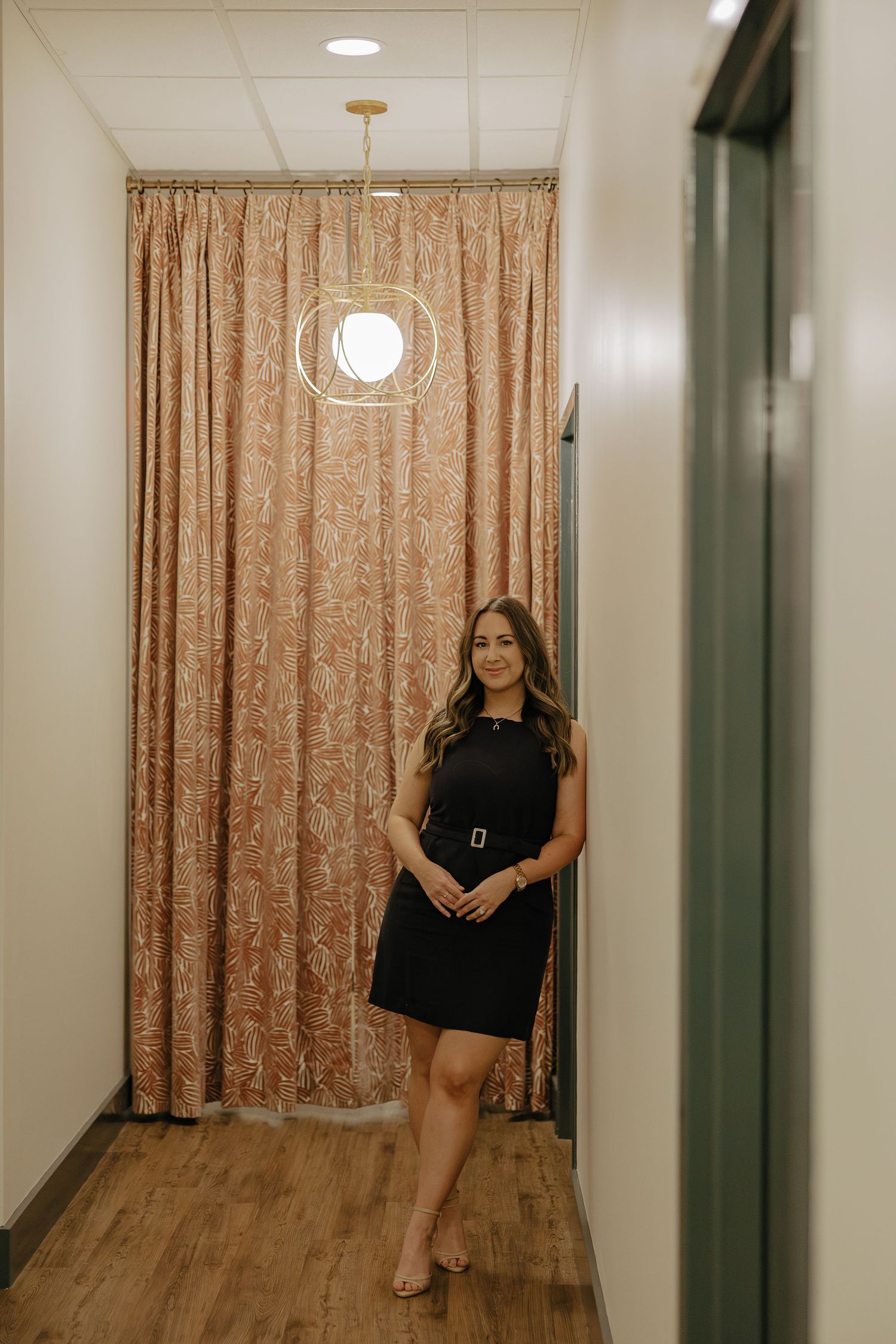Hallway with champagne curtain and modern lighting fixtures.