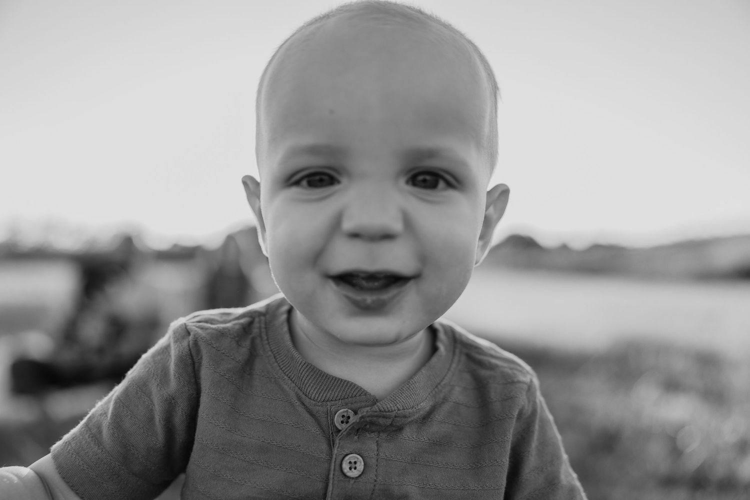 Black and white portrait capturing a joyful expression.