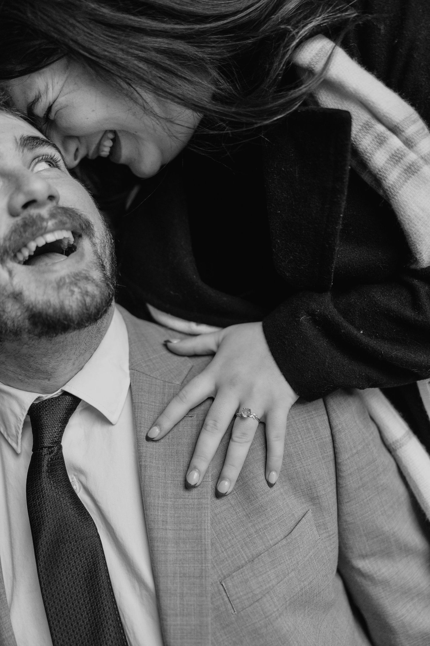 Black and white candid wedding photo series showing joyful laughter and intimate moments between a couple.