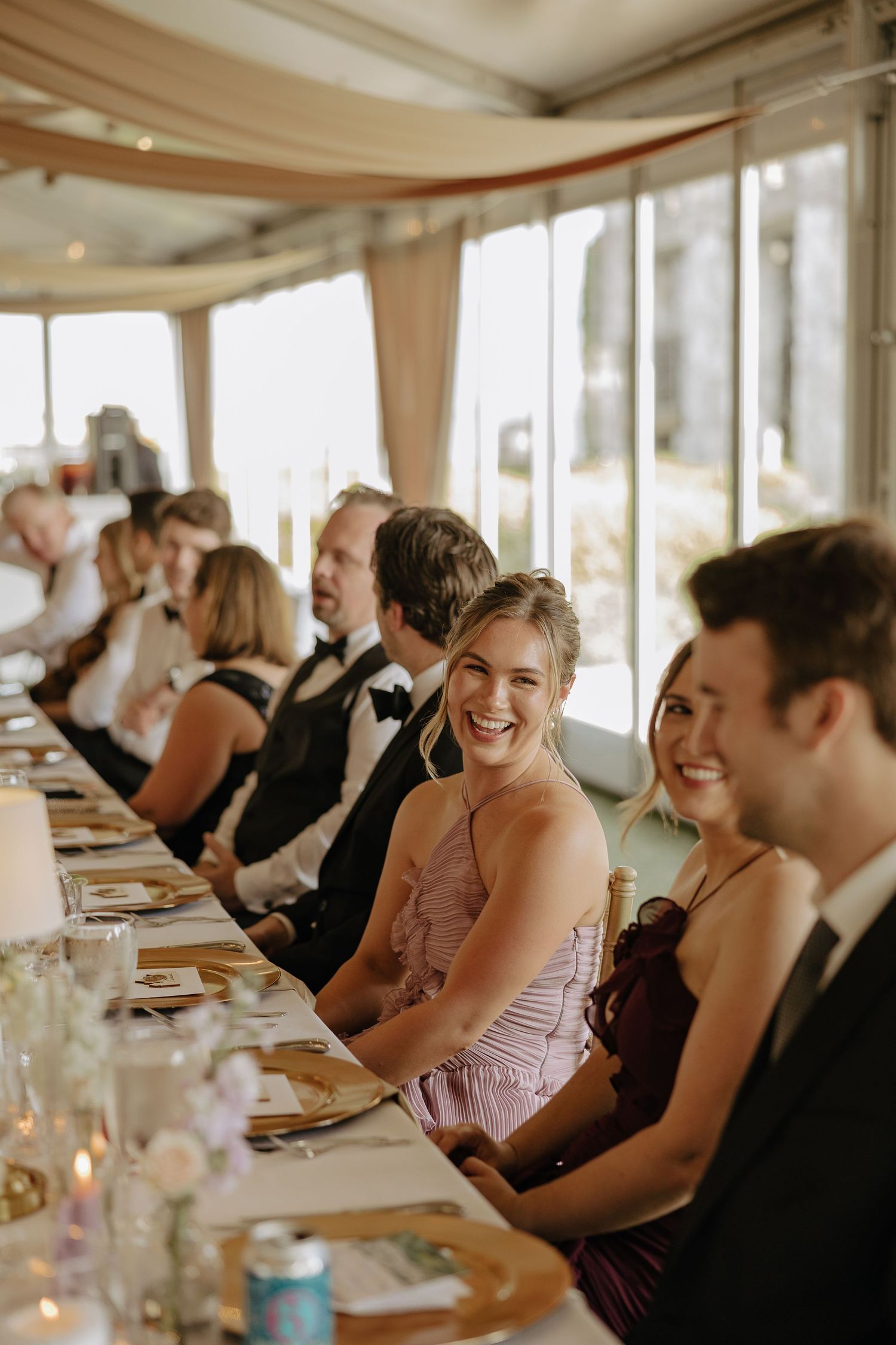 Wedding guests enjoying a celebratory meal at elegant dining tables.