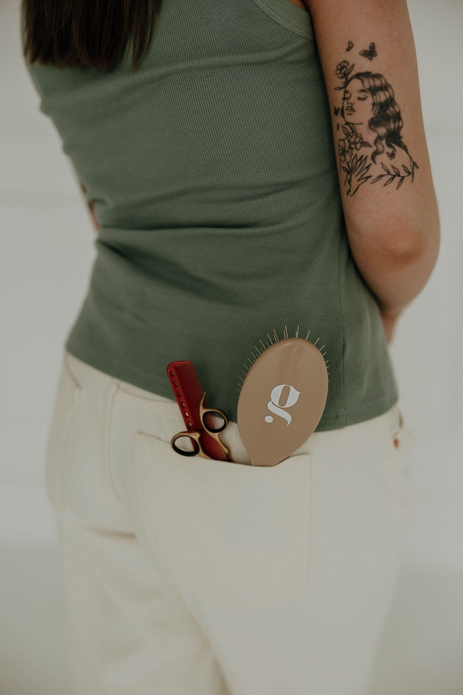 Close-up of tattooed arm with medical supplies in pocket.