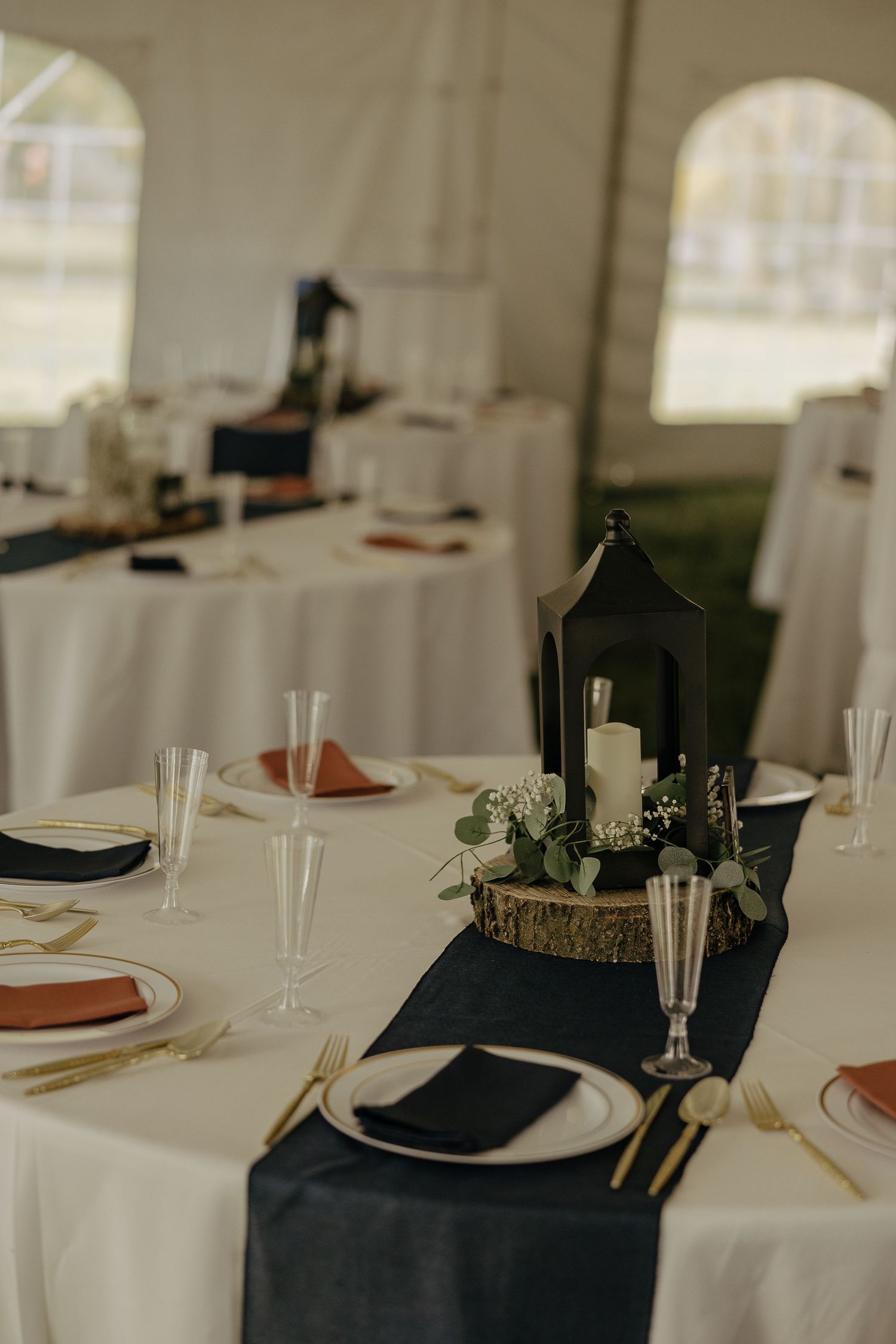 Elegant wedding reception table settings with navy accents and gold details.